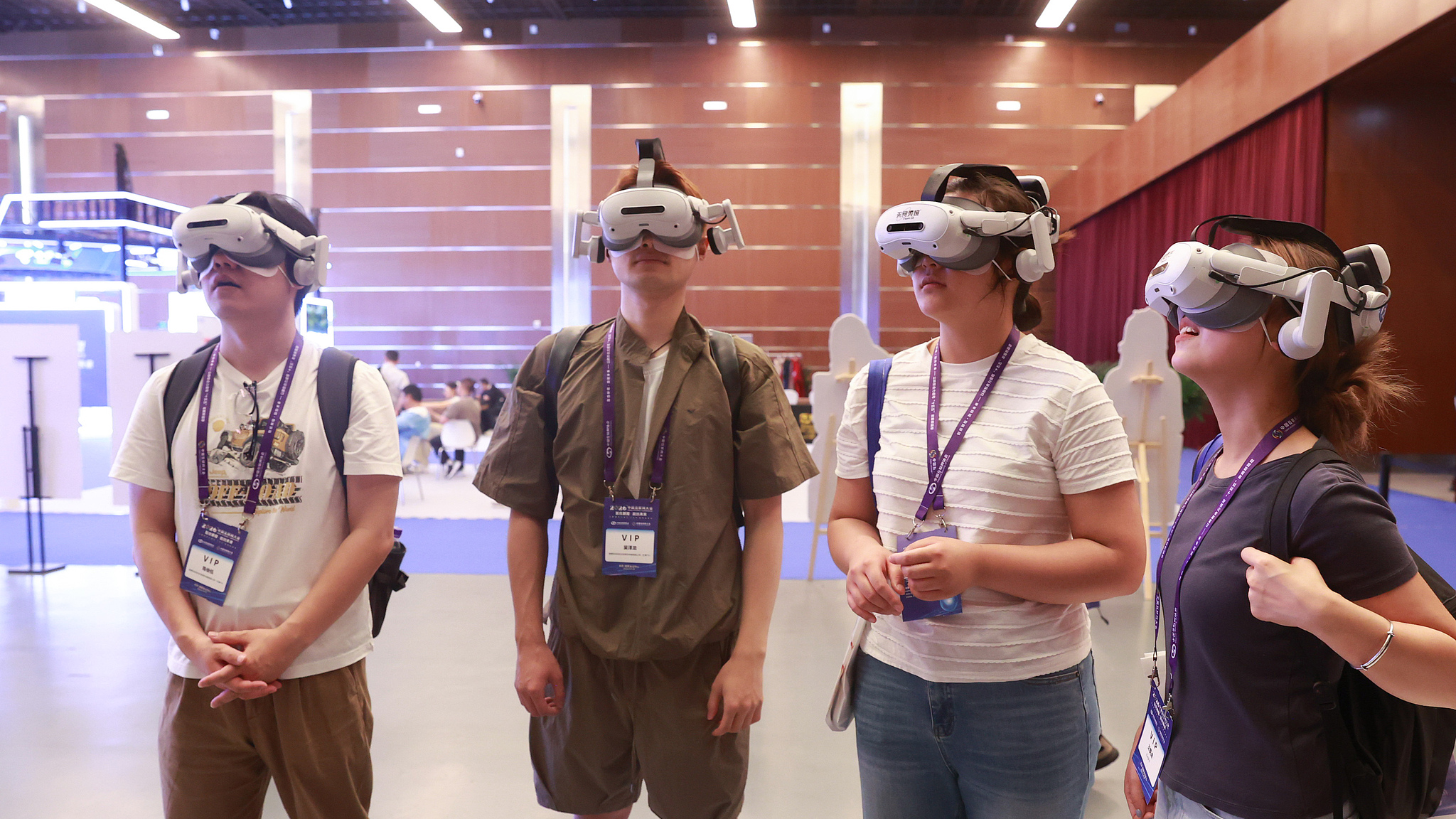 Participants of the 25th China Internet Conference try on VR products at the China National Convention Center in Beijing, capital of China, July 8, 2026. /VCG
