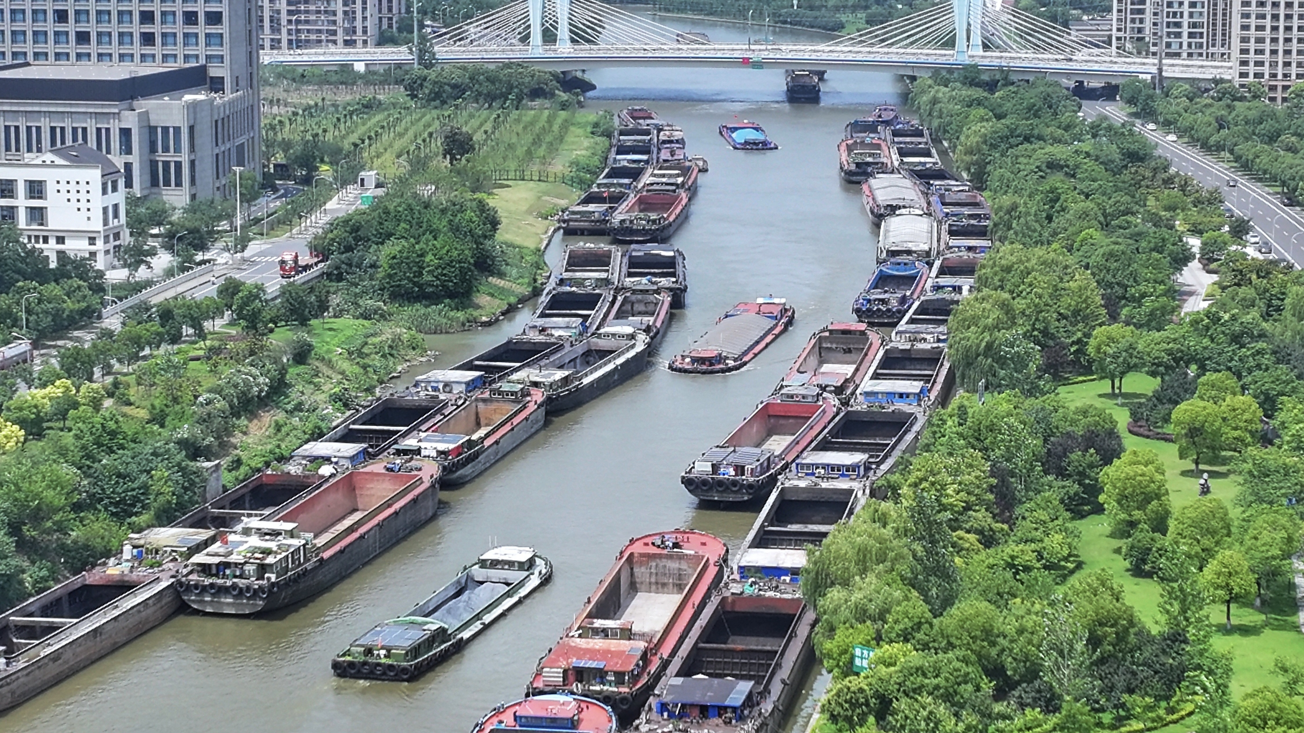 Cargo vessels berth along the Zhangjiagang section of the Shenzhang Waterway in east China's Jiangsu Province on July 9, 2026, after leaving the Yangtze River to shelter ahead of Super Typhoon Bavi. /VCG