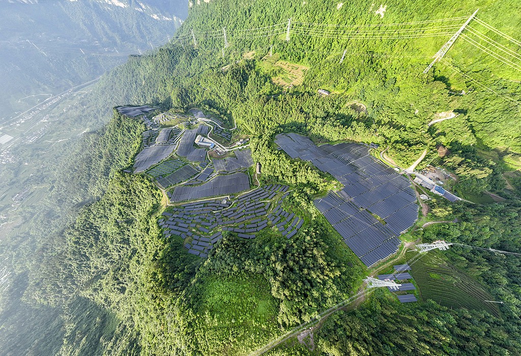 Solar panels amid green mountains under blue skies at a photovoltaic power station in Sixi Village, Maoping Town, Zigui County, Yichang, Hubei Province, China, May 31, 2026. /VCG