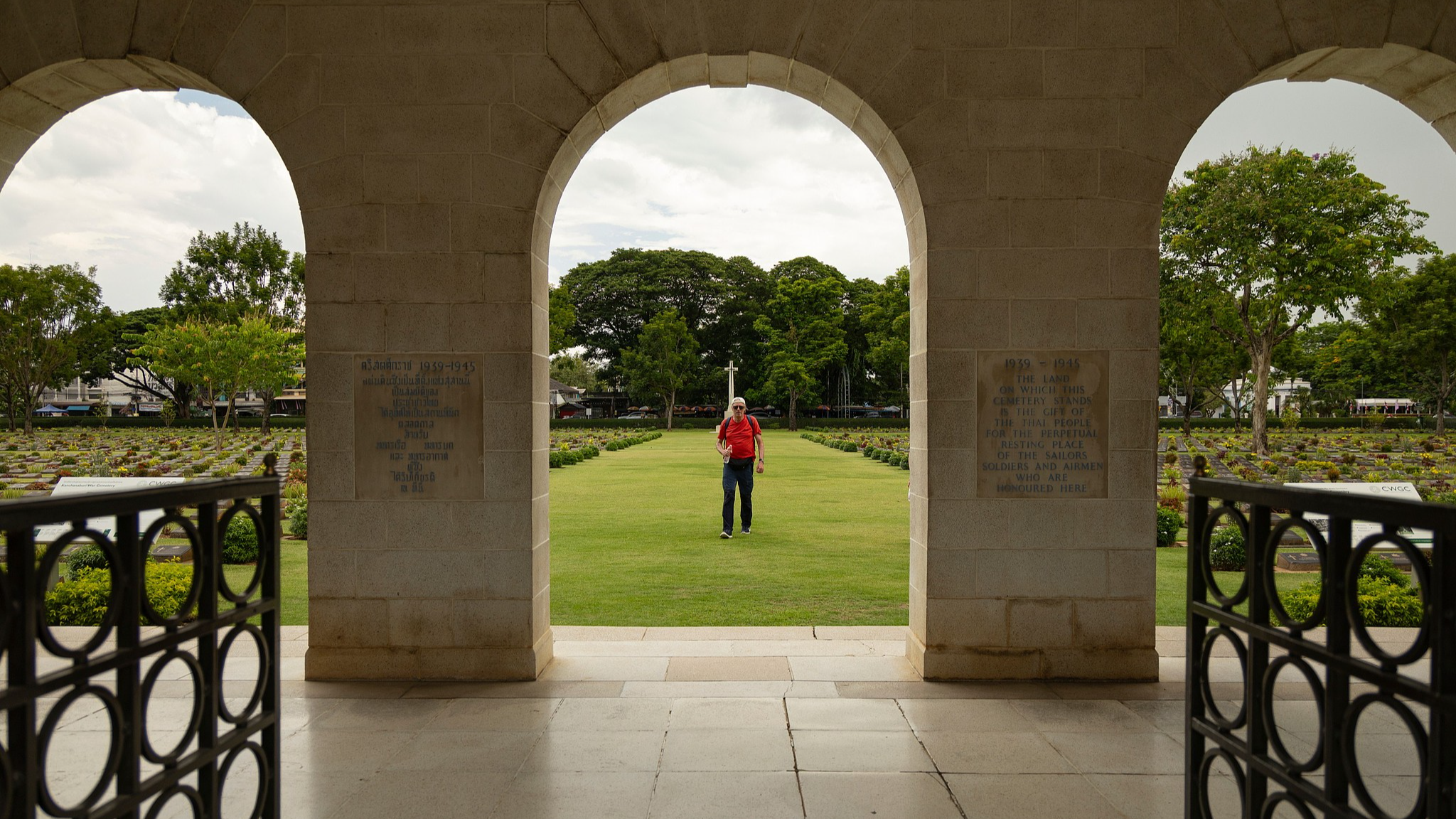 A visitor walks through the Don-Rak War Cemetery for the prisoners of war who died building the infamous World War II 