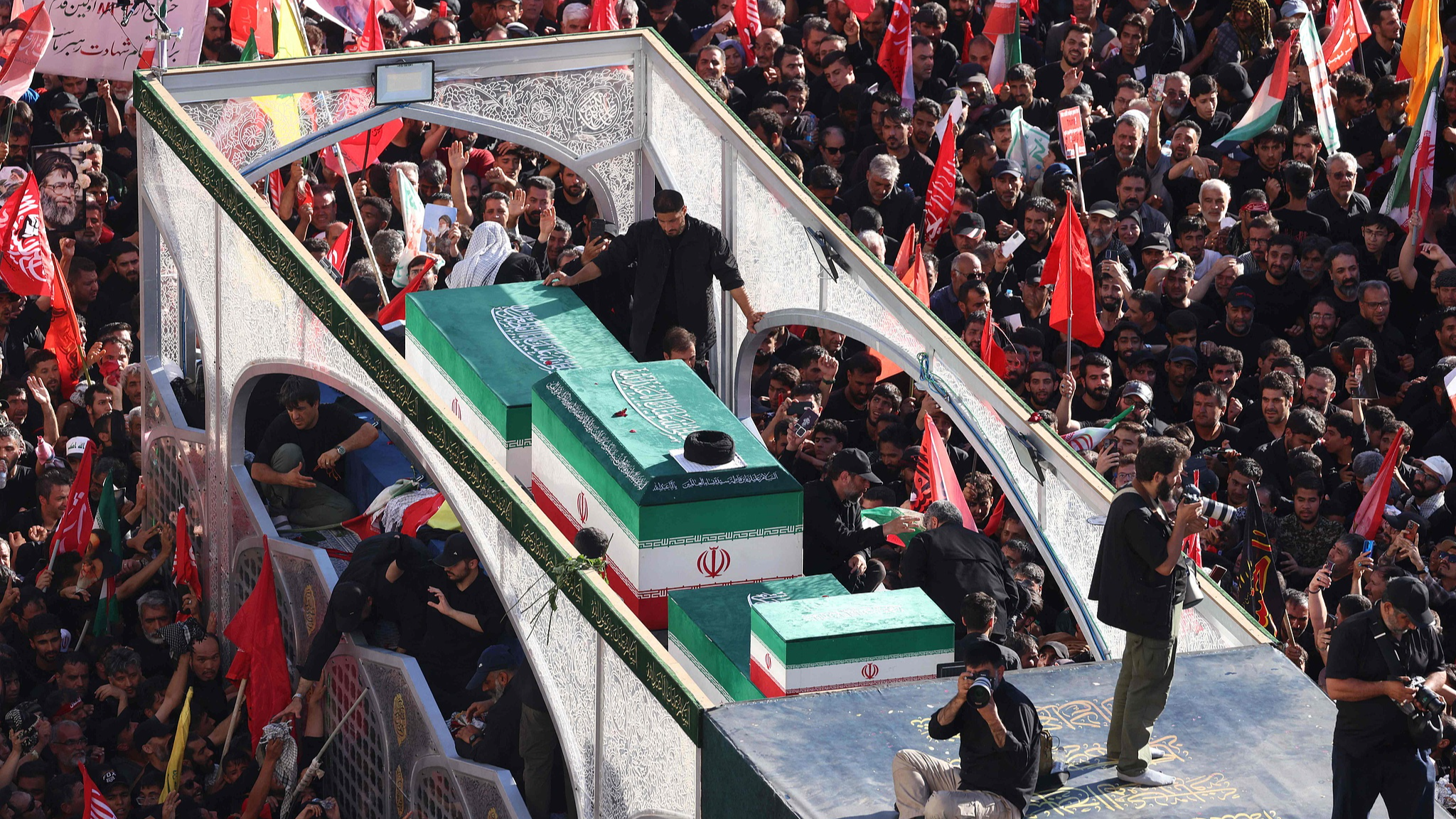 Crowds of mourners surround the convoy carrying the coffins of Iran's slain Supreme Leader Ali Khamenei and members of his family during a funeral procession in Mashhad, Iran, July 9, 2026. /VCG