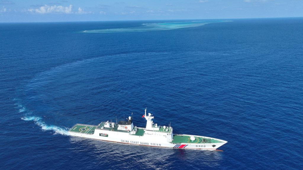 An aerial photo of the China Coast Guard vessel Sandu patrolling near a reef in the South China Sea, March 24, 2026. /Xinhua