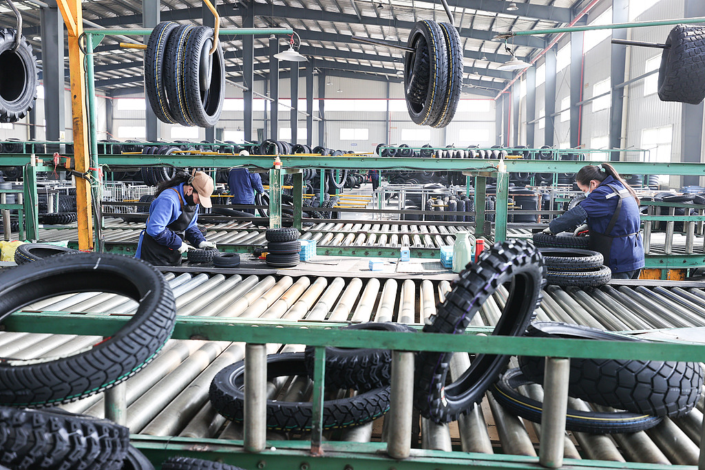 Workers manufacture tires for export to Germany at a workshop in Lianyungang City, east China's Jiangsu Province, March 9, 2026. /CFP
