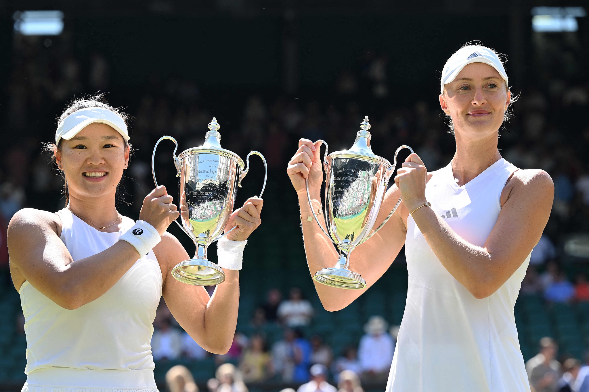 China's Guo Hanyu (L) and France's Kristina Mladenovic pose with their trophies after beating Canada's Gabriela Dabrowski and Brazil's Luisa Stefani in the women's doubles final at the Wimbledon Championships in London, England, UK, July 12, 2026. /VCG