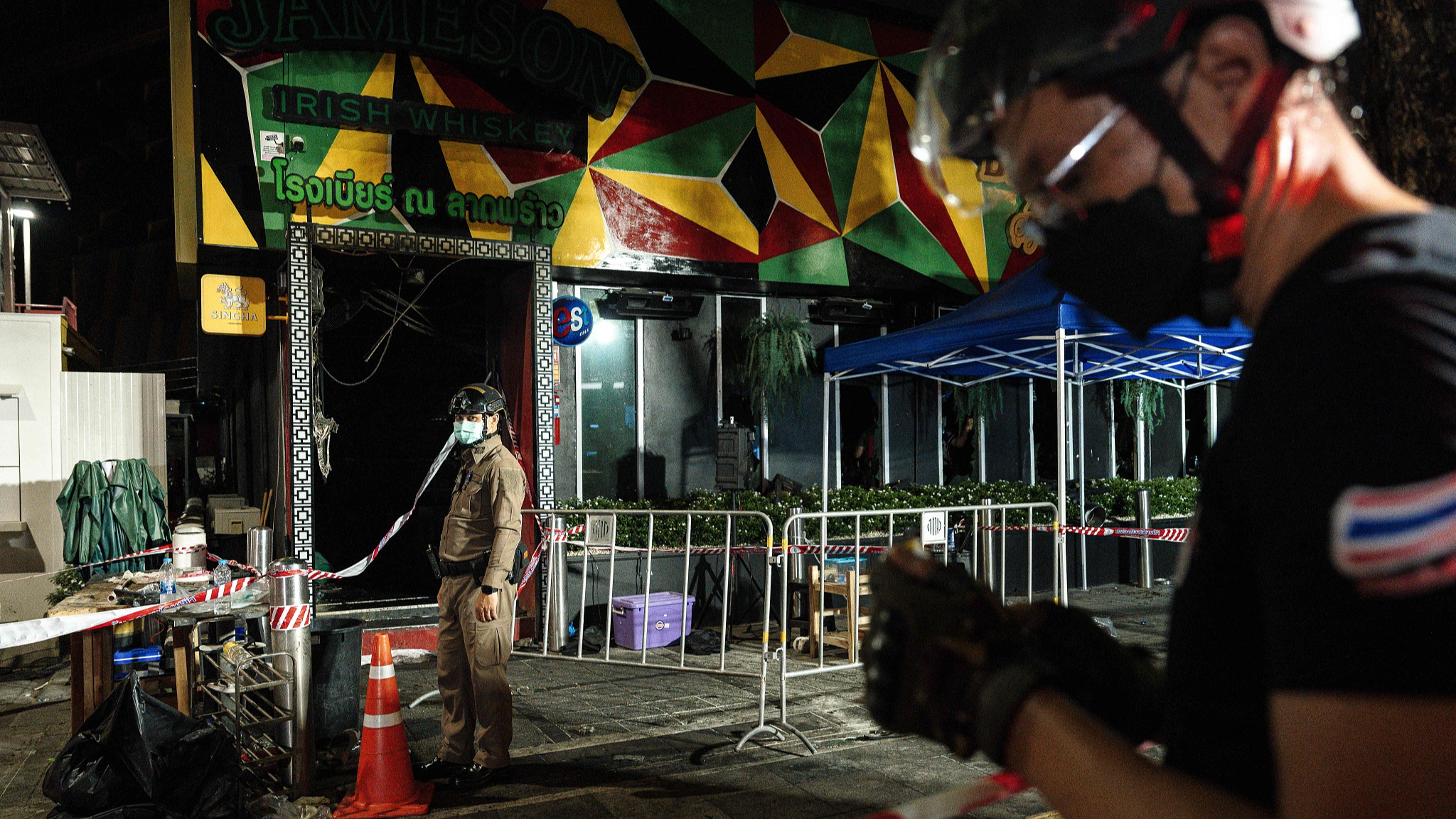 Police stand guard outside the burnt remains of a bar in Bangkok, Thailand, July 13, 2026. /VCG