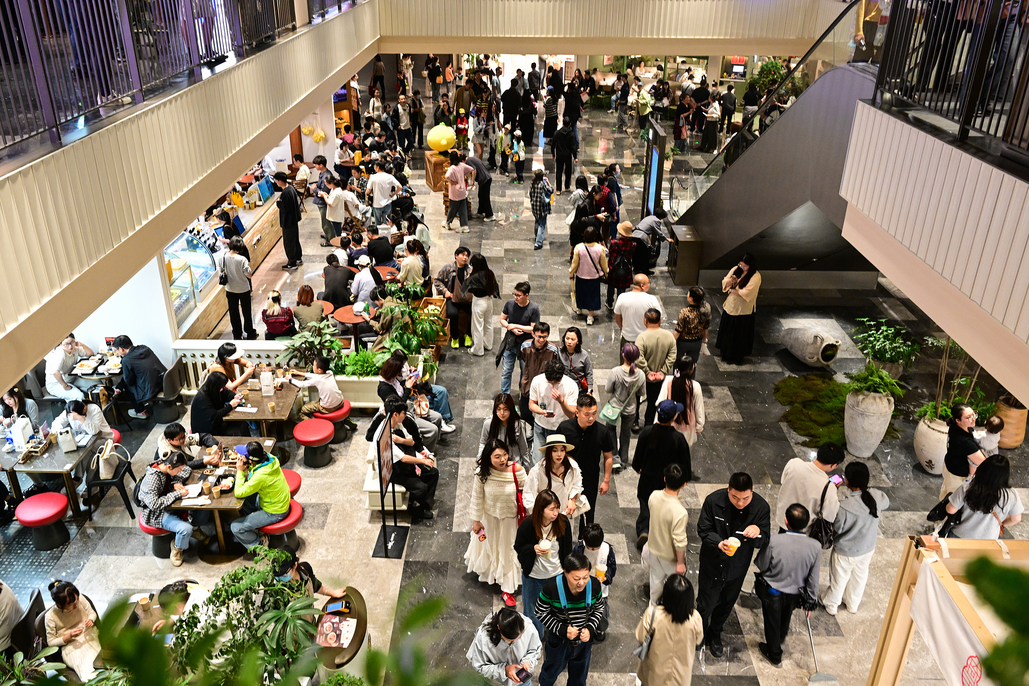 Bustling crowds are seen in a commercial district in Suzhou, Jiangsu Province, China, May 4, 2026. /VCG