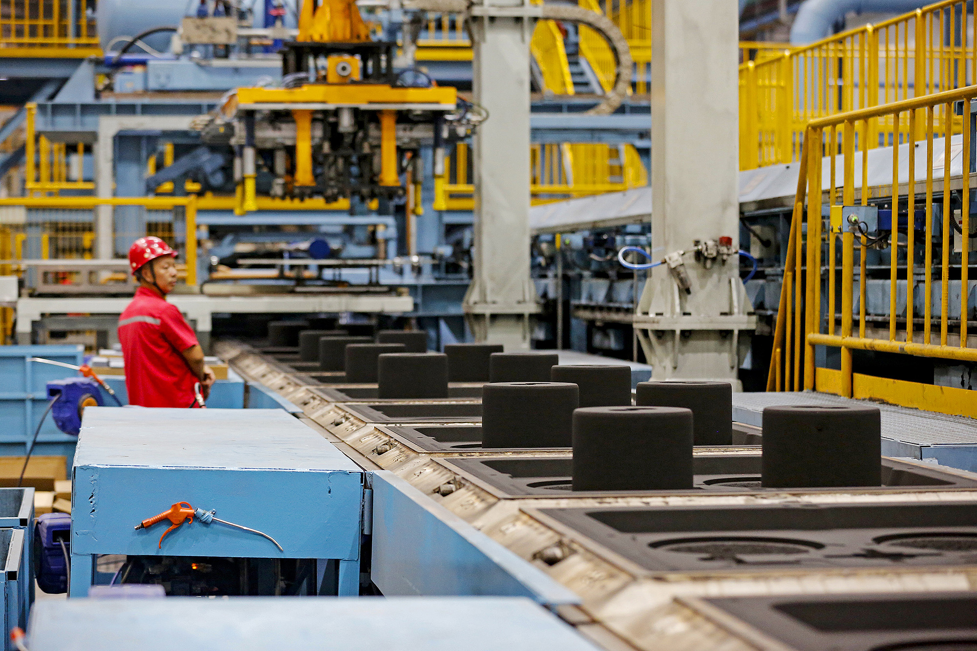A worker operating on an automated production line in a manufacturing company in Shanxi Province, China, July 11, 2026. /VCG