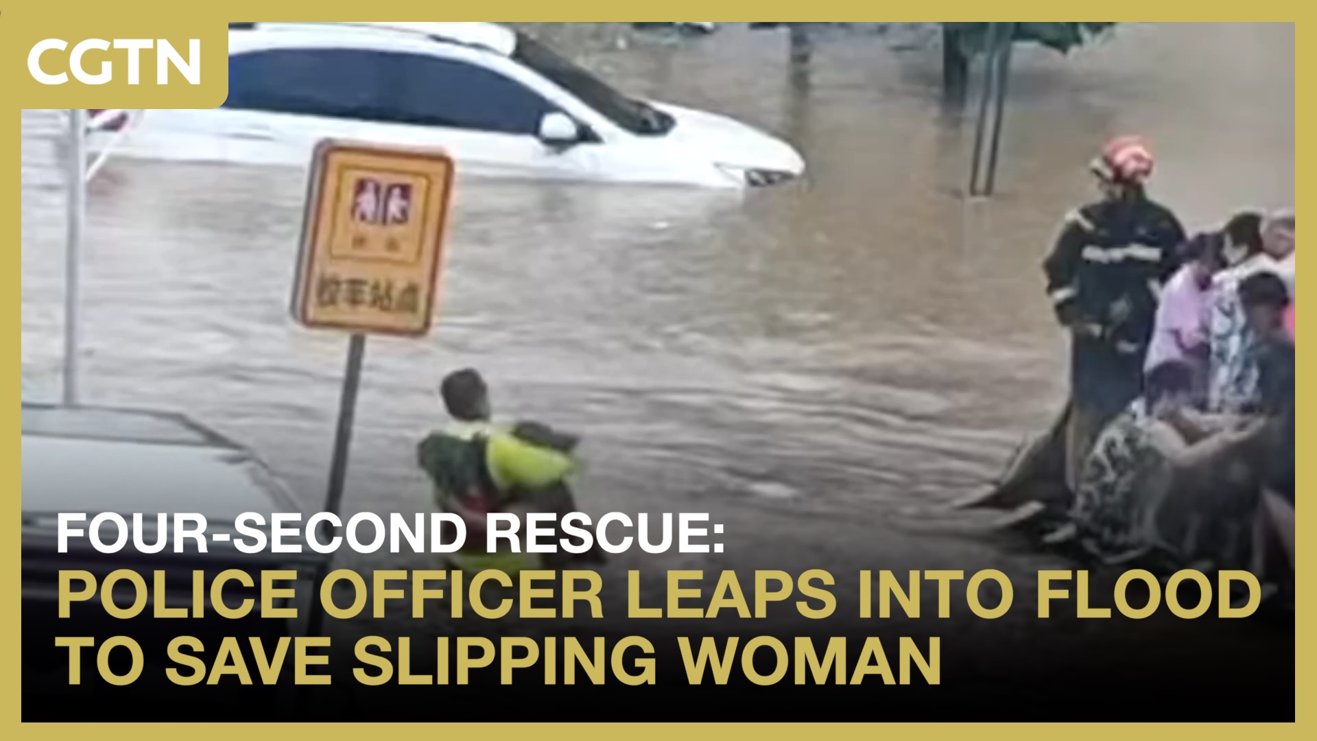 Police officer leaps into flood to save slipping woman