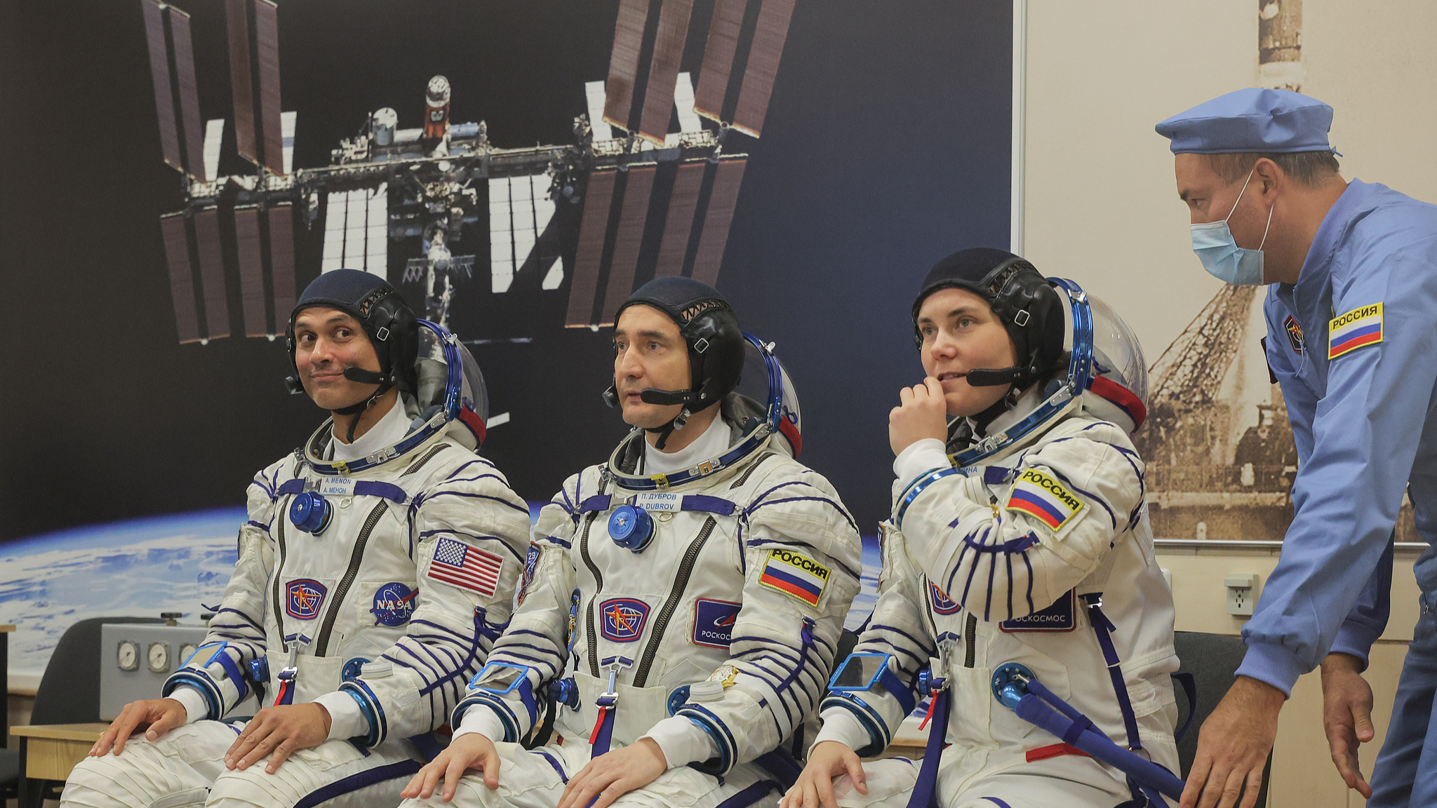 (L-R) Crew members NASA astronaut Anil Menon, Roscosmos cosmonauts Pyotr Dubrov and Anna Kikina check their space suits prior to the launch of the Soyuz MS29 spacecraft at the Baikonur Cosmodrome in Baikonur, Kazakhstan, July 14, 2026. /VCG