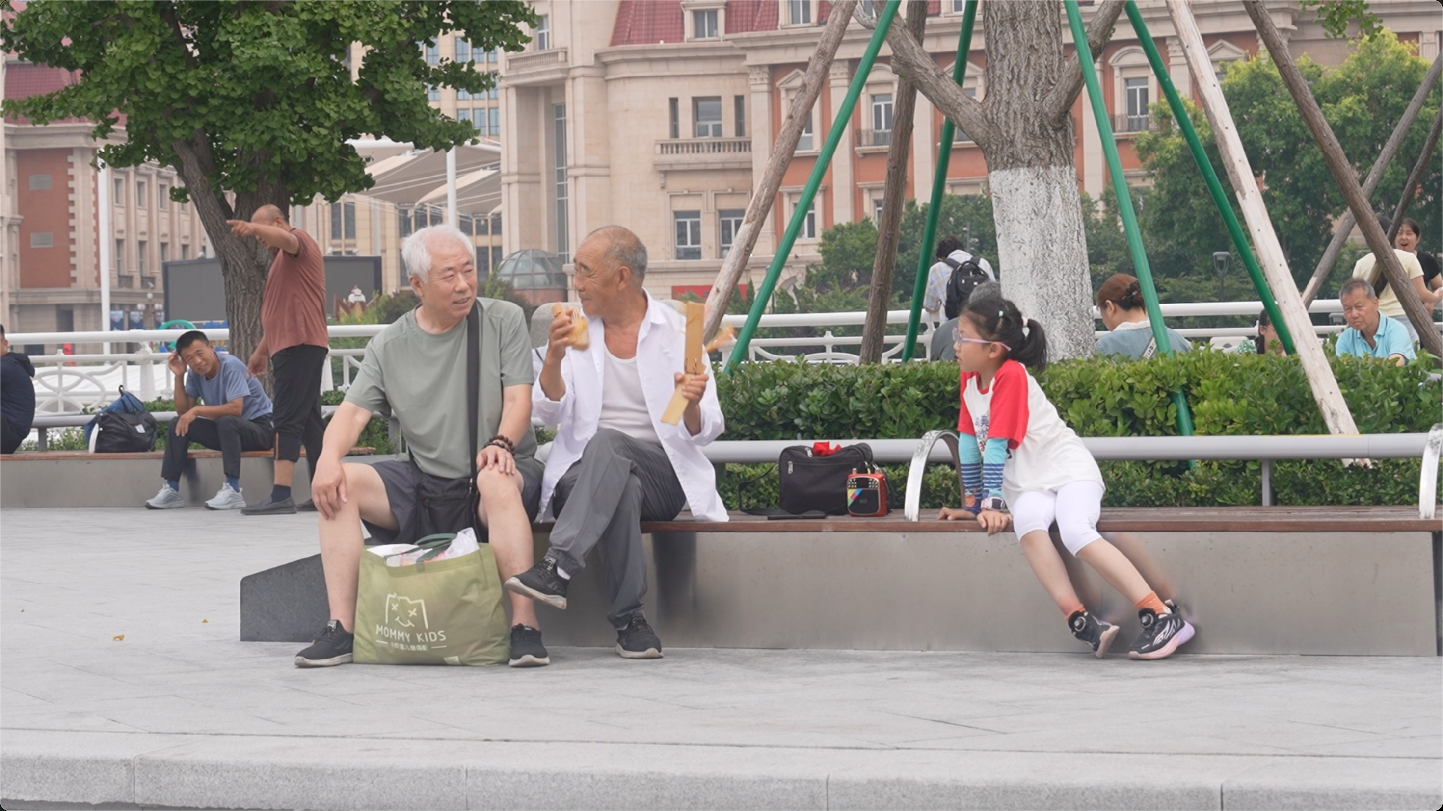 Two elderly men chat while playing kuaiban (traditional Chinese clappers) along the riverside in Tianjin, northern China on July 10, 2026. /CGTN