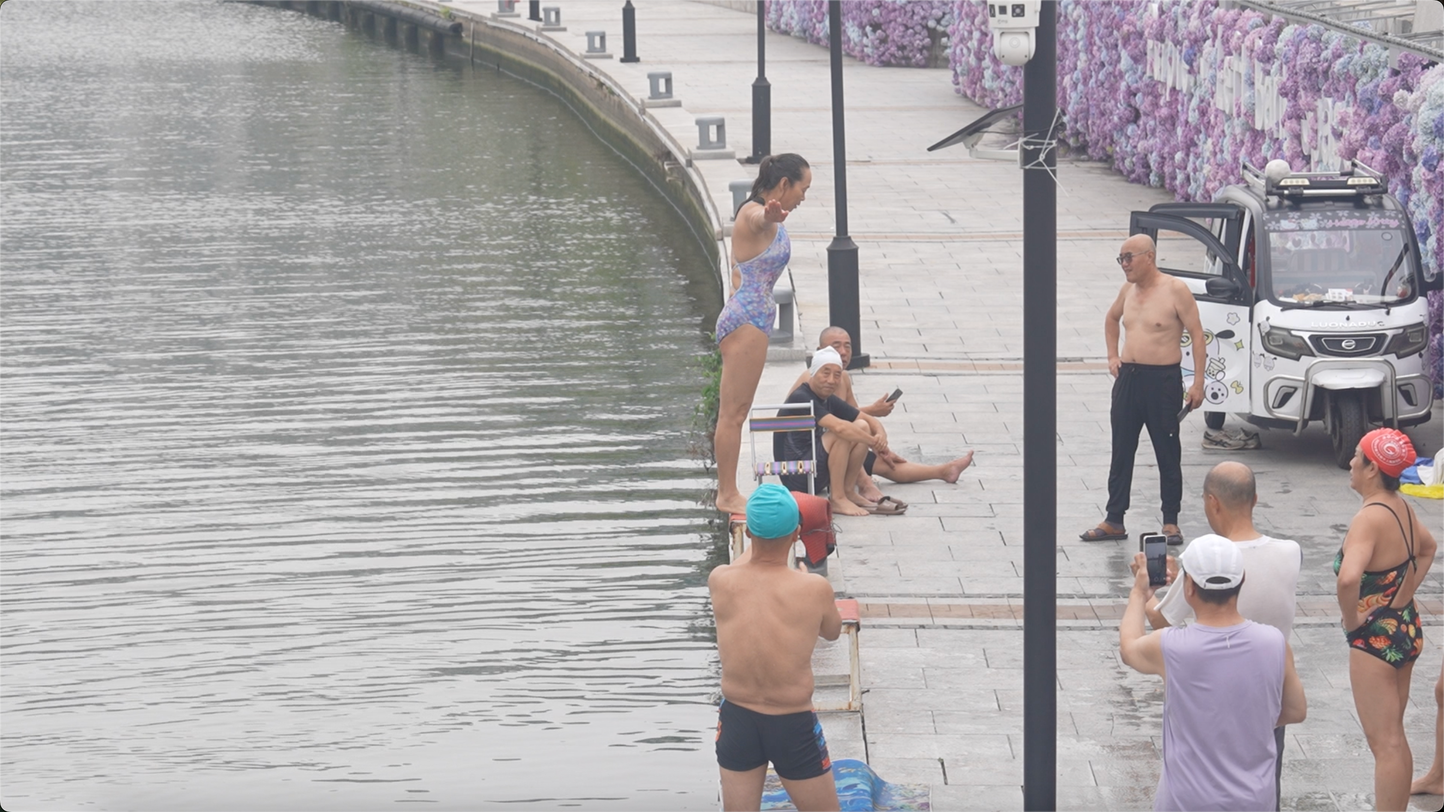 A group of elderly people dive into the Haihe River, in Tianjin, northern China on July 10, 2026. /CGTN