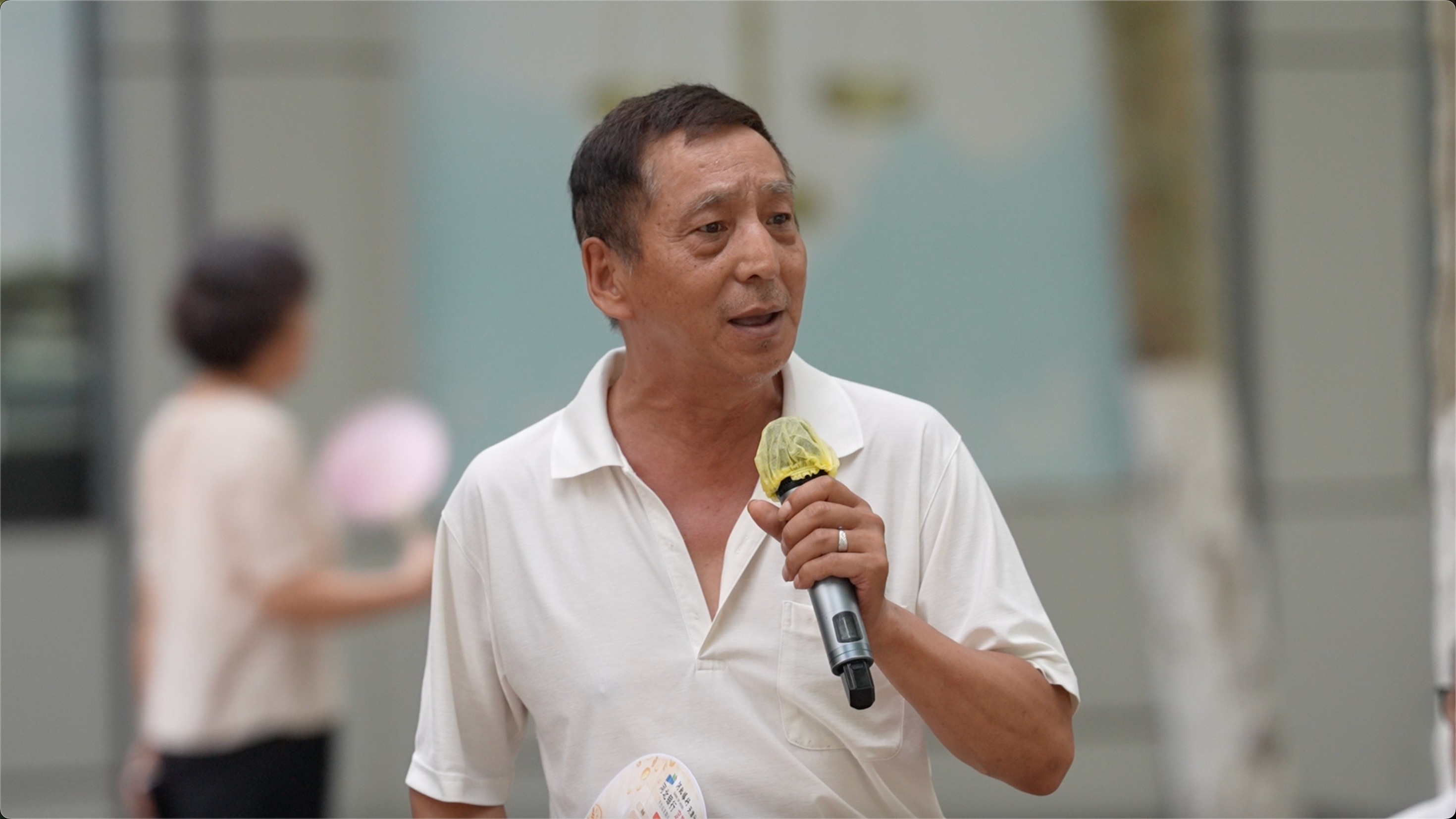 An elderly man sings in the public area alongside the Haihe River, in Tianjin, northern China on July 9, 2026. /CGTN