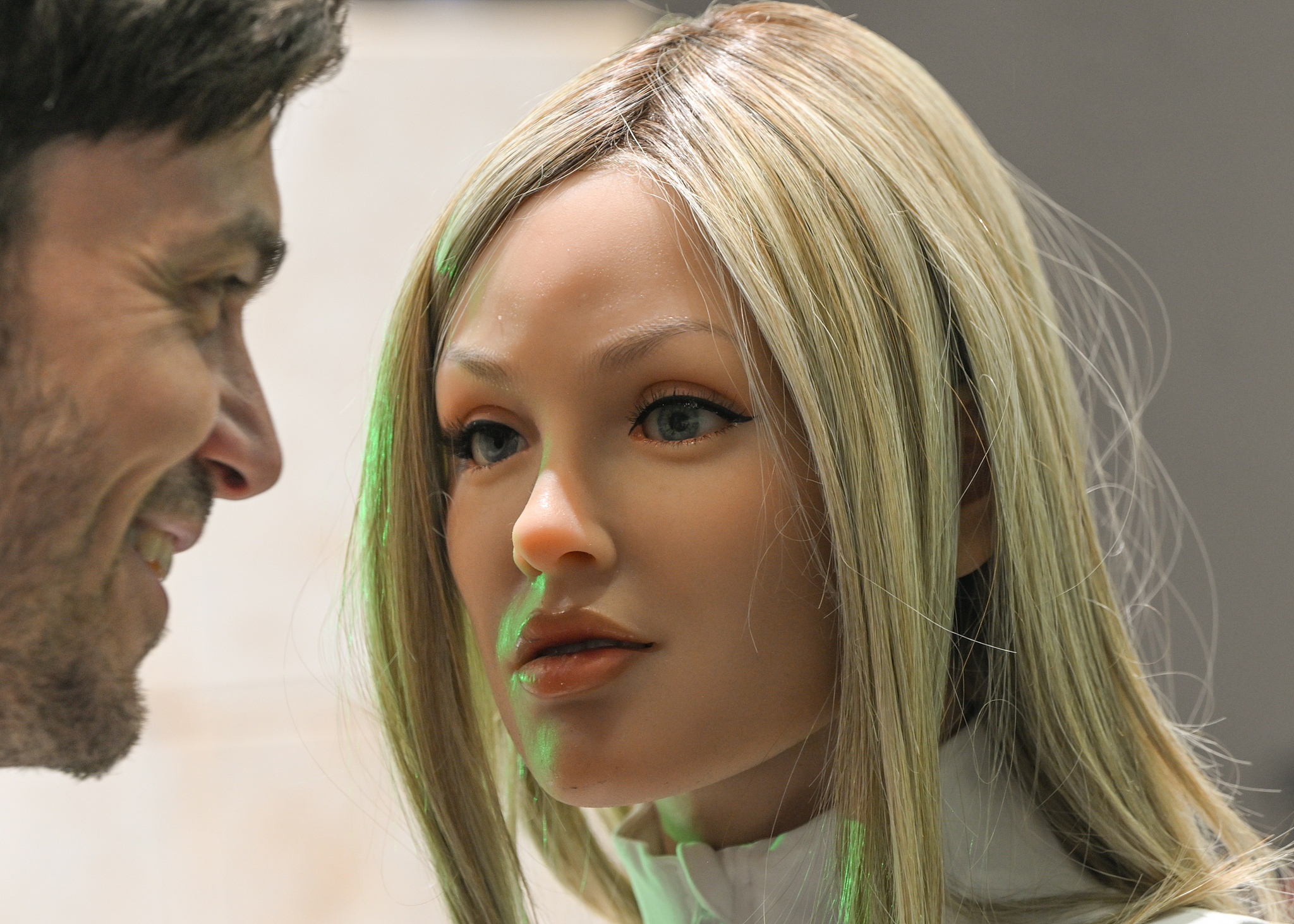 A member of the public interacts with the Realbotix AI-powered humanoid robot, designed for companionship, entertainment and customer service, on display at IFA 2025 in Berlin, Germany, on September 6, 2025. /VCG