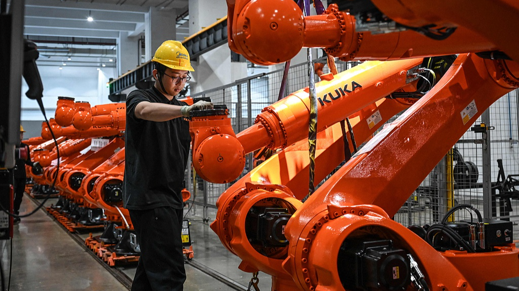 A worker working on an industrial robot assembly line at a factory in Foshan, southern China's Guangdong Province, March 17, 2026. /VCG