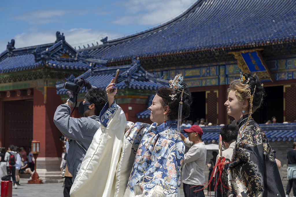 Visitors explore and snap photos at the Temple of Heaven, Beijing, China, June 9, 2026. /VCG