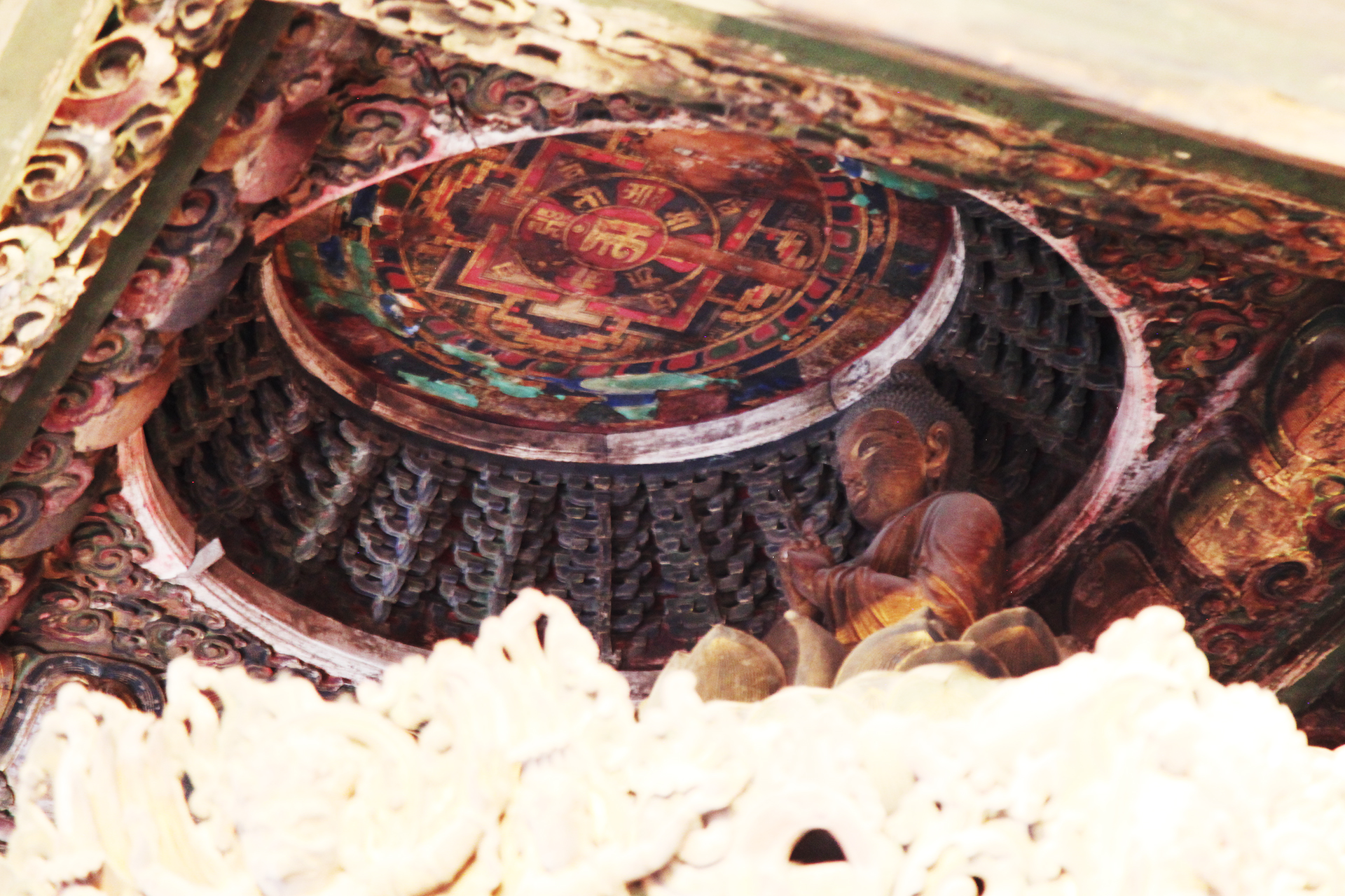 Situated above Beijing's only surviving Ming Dynasty Zhuanlunzang, an exquisite wooden sutra cabinet standing more than four meters tall, the only remaining caisson ceiling at the Zhihua Temple can only be viewed from certain angles inside the hall where it is located. /CGTN