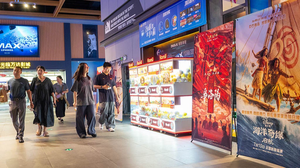 Moviegoers walk past posters for summer releases at a cinema in Nantong, China's Jiangsu Province, on July 13, 2026. /VCG 