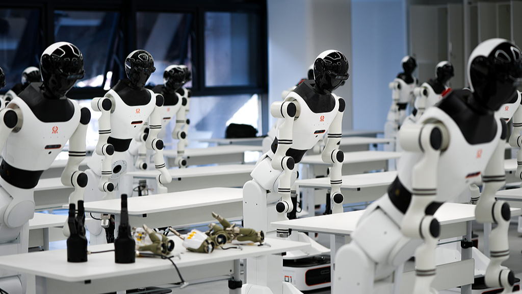 Humanoid robots wait for training at the humanoid robot data training center in Shougang Park, Beijing, March 27, 2025. /VCG