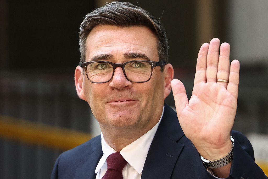 Andy Burnham waves as he leaves Labour's 