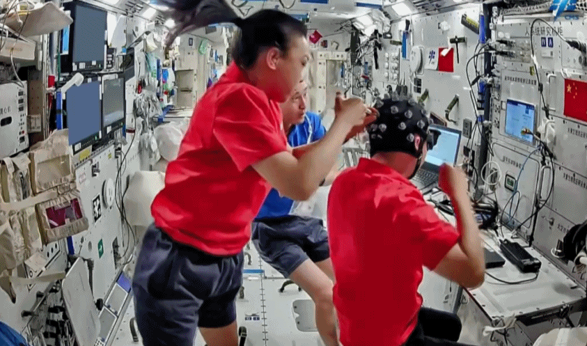 The Shenzhou-23 crew using the electroencephalogram data acquisition equipment to conduct relevant tests. /CMG