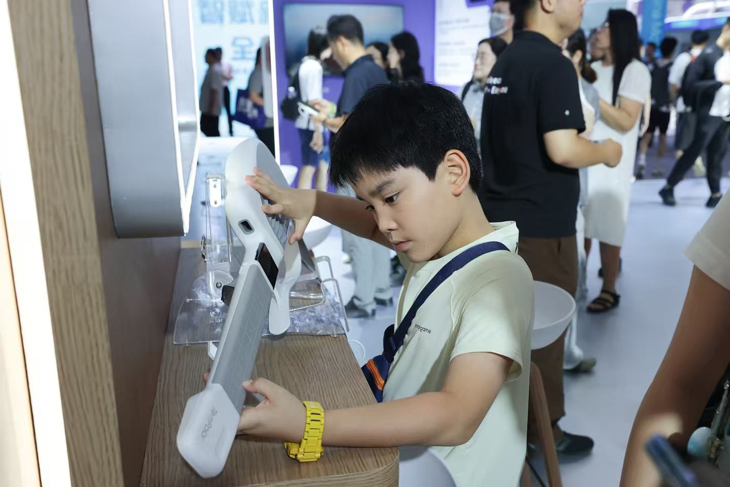 A child experiences an AI-powered guitar at the 2026 World Artificial Intelligence Conference in Shanghai, China, July 20, 2026. /VCG