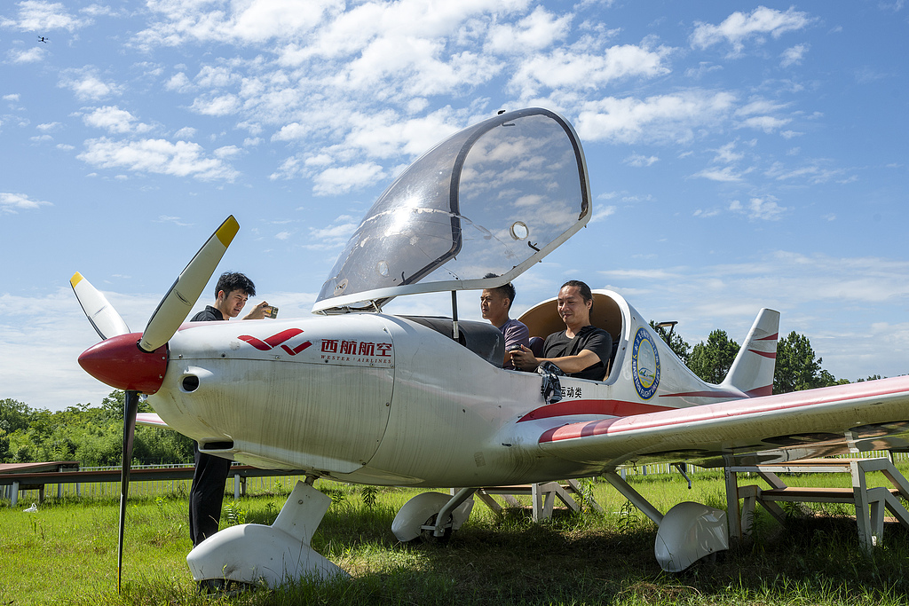 Tourists ride on a small fixed-wing aircraft at the Dongfangfeigu Aviation Flight Camp, Anhui Province, China, July 9, 2026. /VCG