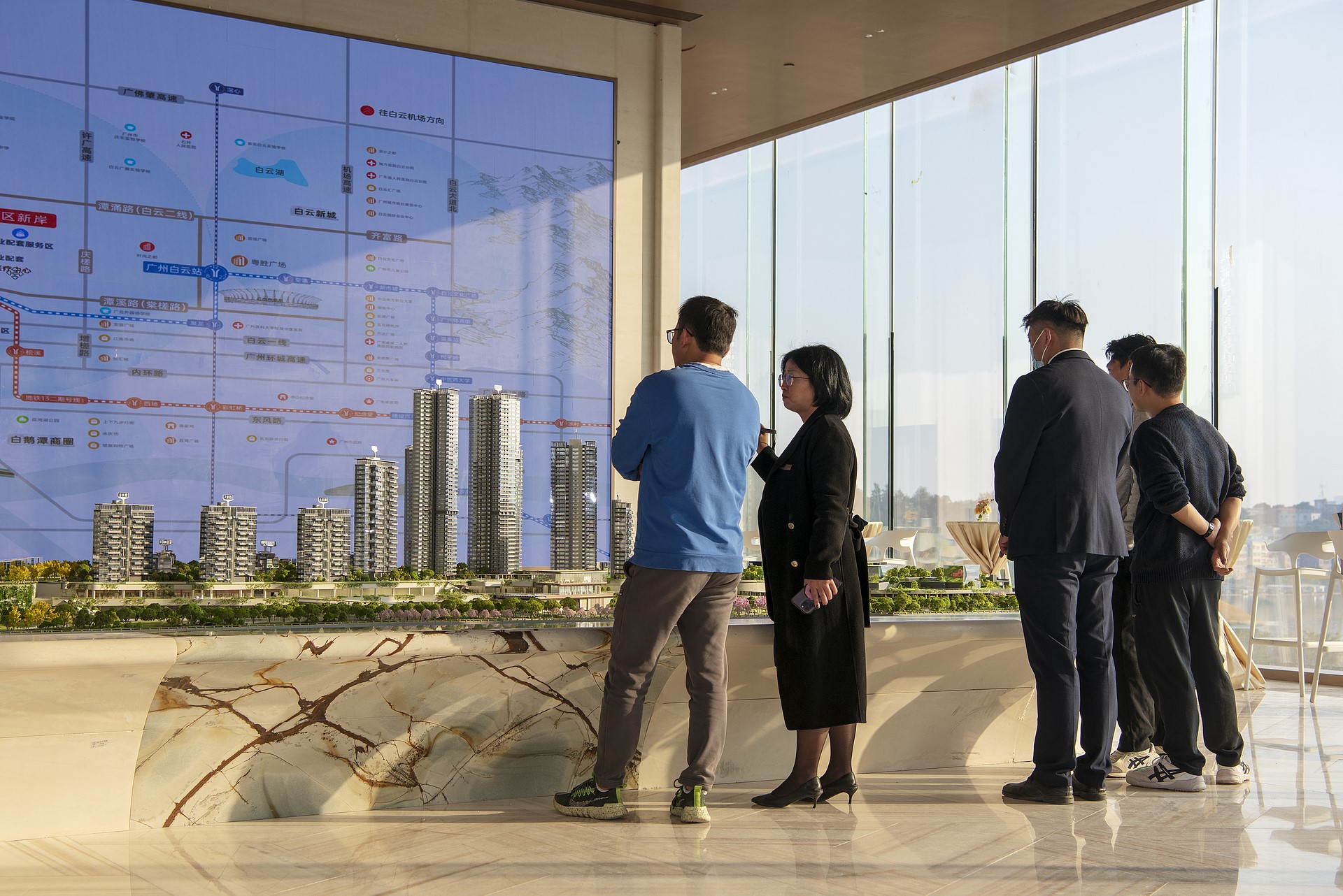 Homebuyers consult sales representatives at a real estate showroom in Guangzhou, Guangdong Province, China, December 28, 2025. /VCG