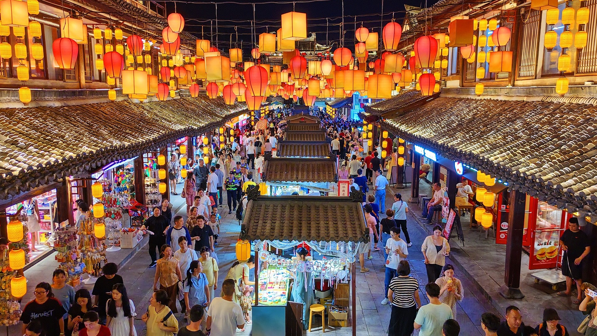 Tourists explore a historic cultural district, enjoying local cuisine and leisure activities during the summer travel season in Ganzhou, east China's Jiangxi Province, July 18, 2026. /VCG