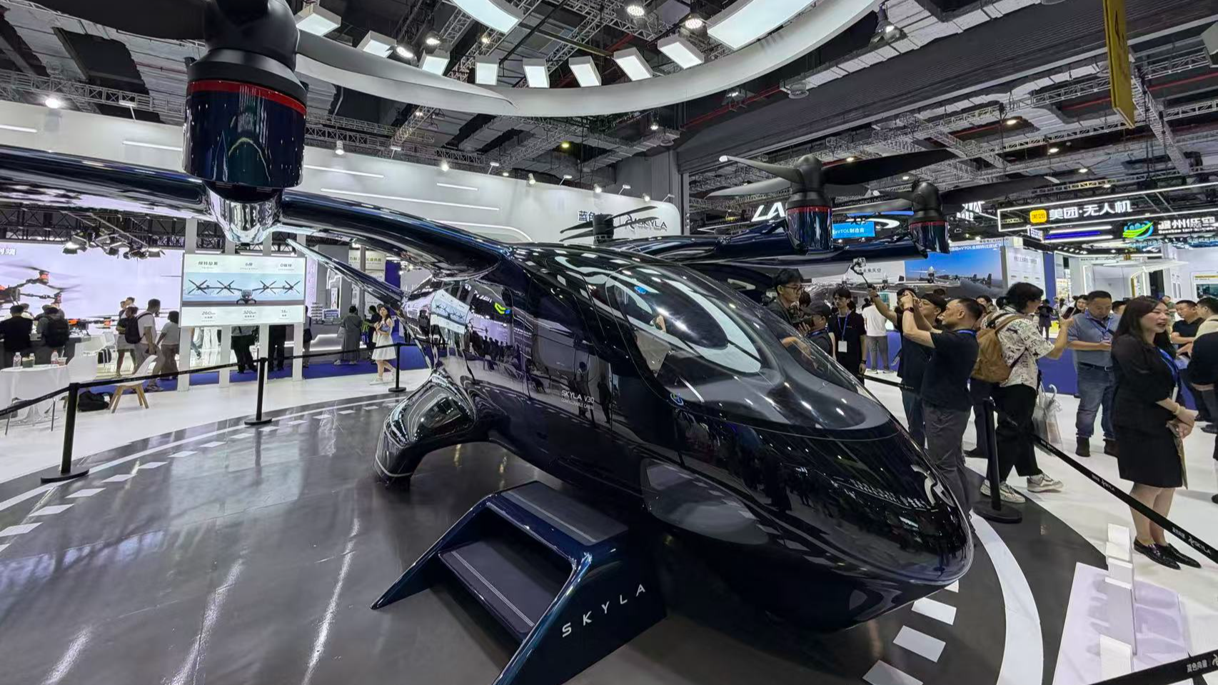 Visitors take pictures of an eVTOL model at the 2026 International Advanced Air Mobility Expo, Shanghai, July 22, 2026. Wu Bin/ CGTN