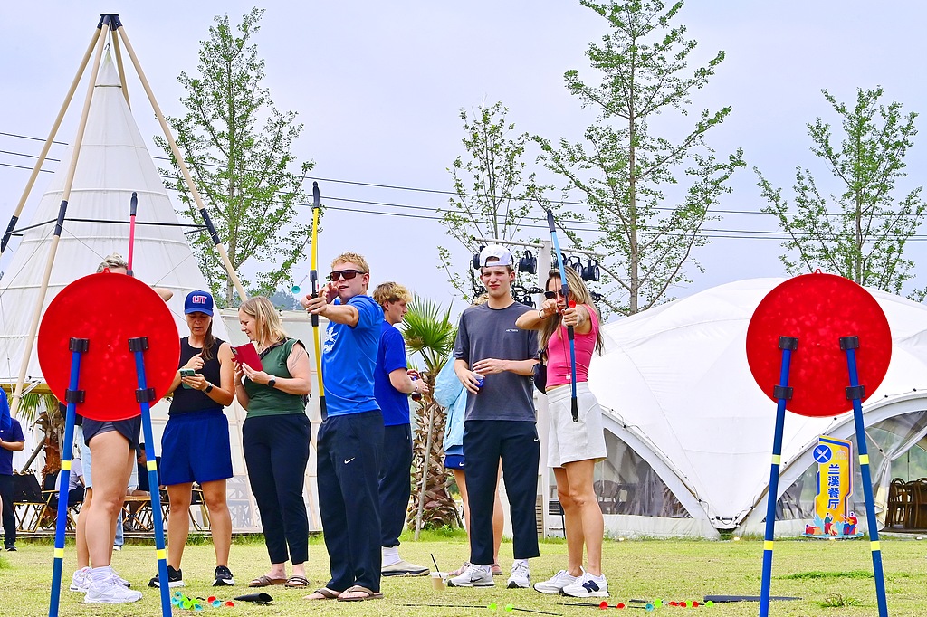 Foreign tourists try their hand at traditional archery at a rural tourism site in Panjiang Village, Jiangxi Province, east China, May 10, 2026. /VCG