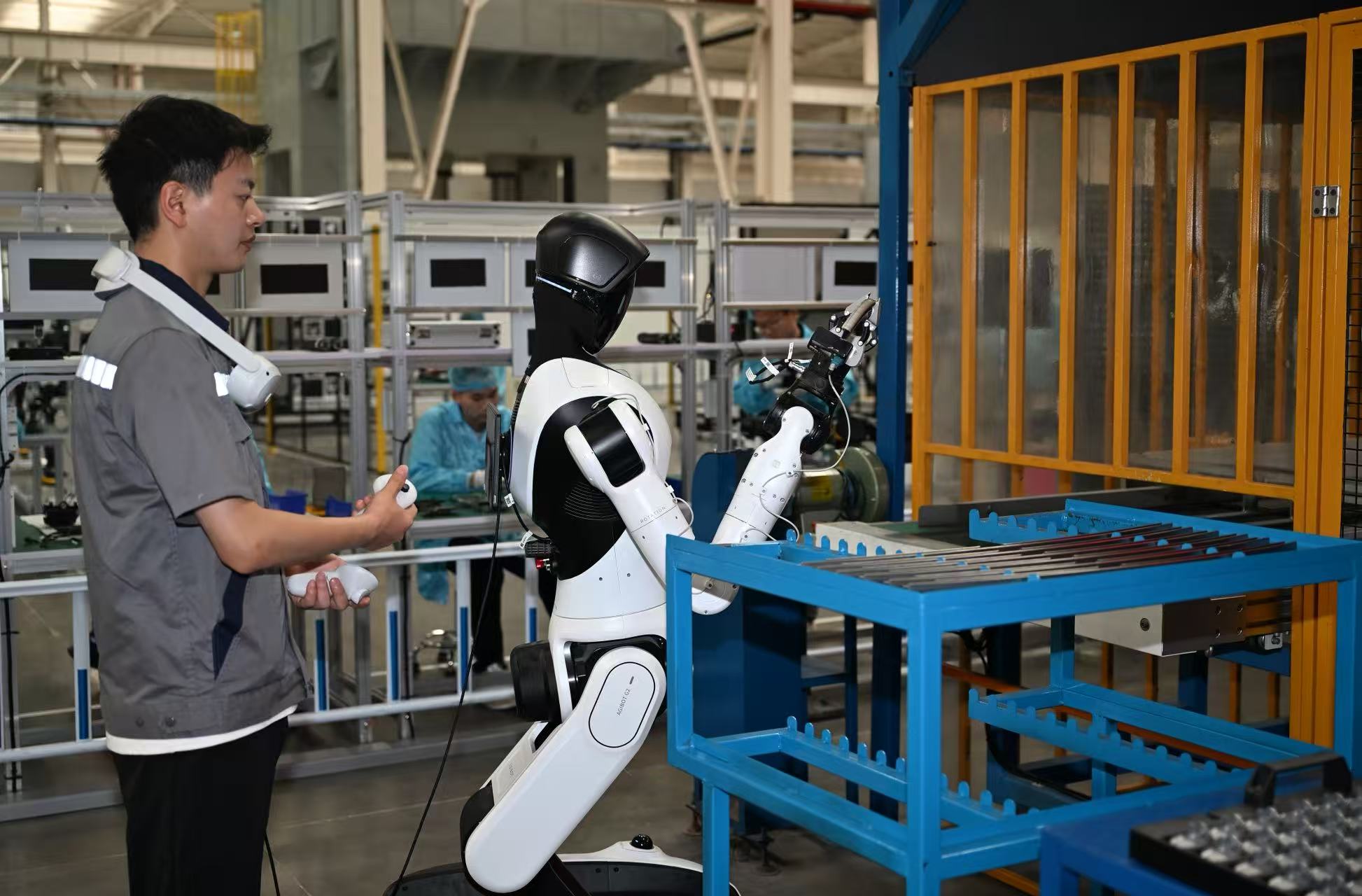 A humanoid robot works on a production line at a smart factory in Jiaxing, Zhejiang Province, China, May 27, 2026. /VCG