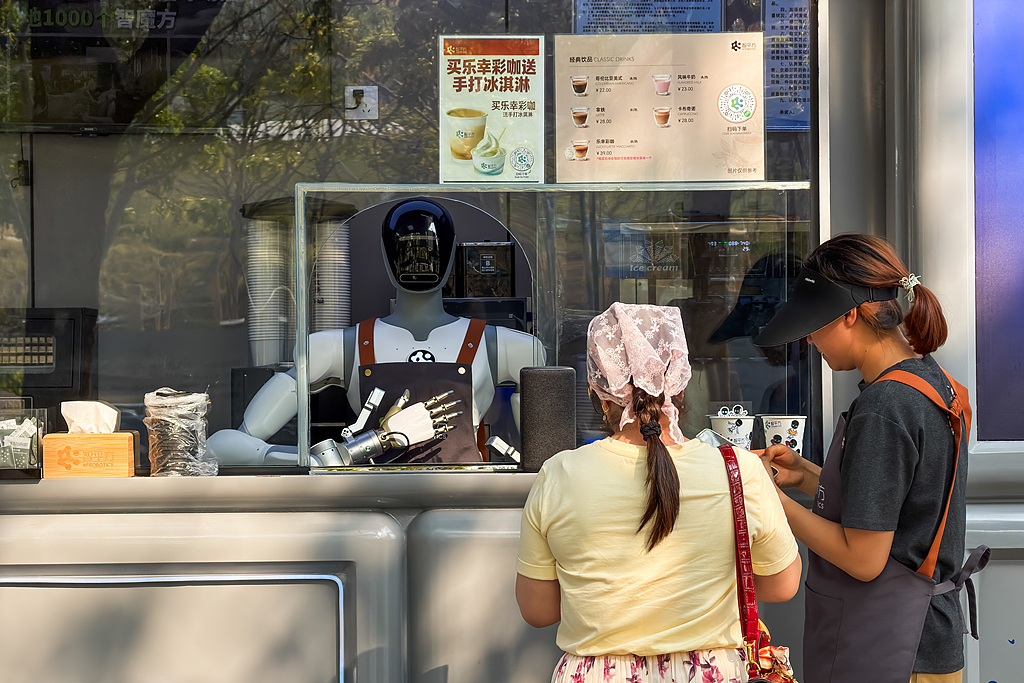Customers place an order at a robot-operated coffee kiosk on March 25, 2026 in Shenzhen, Guangdong province, China. /VCG