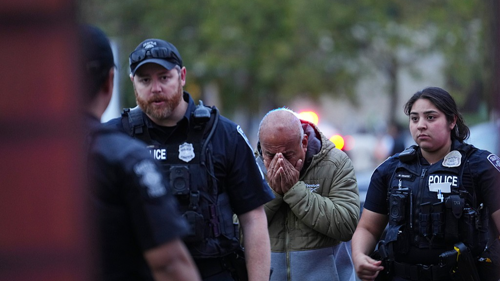 An unidentified man is led into the scene by police after they responded to a shooting at Seattle Center during the Bite of Seattle food festival in Seattle, Washington, US, July 26, 2026. /VCG