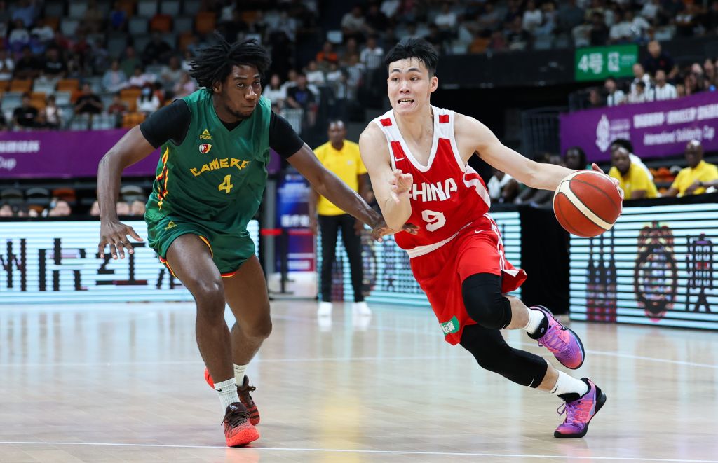 China guard Pang Zhenglin (R) drives against Cameroon guard Valentin Lele in a basketball game at the International Solidarity Cup in Haikou, south China's Hainan Province, July 27, 2026. /Xinhua