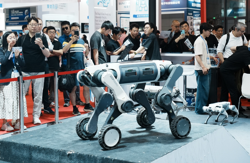 Visitors watch a DEEP Robotics quadruped demonstrate climbing stairs at a robot exhibition in Hangzhou, Zhejiang Province, east China, May 14, 2026. /CFP