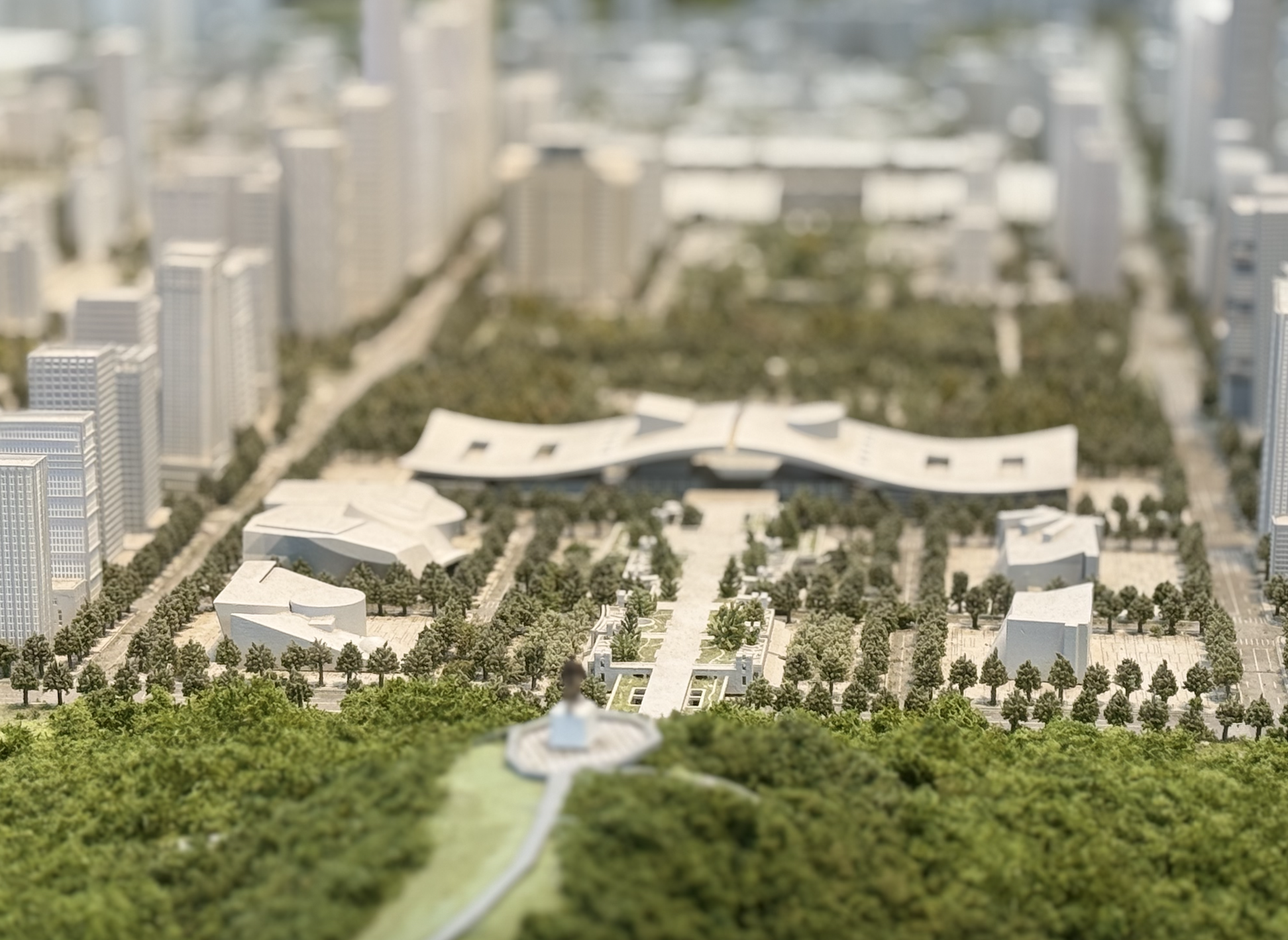 A closer look at the model of the Civic Center with wave-shaped roof and the museum building beside it rendered in miniature.