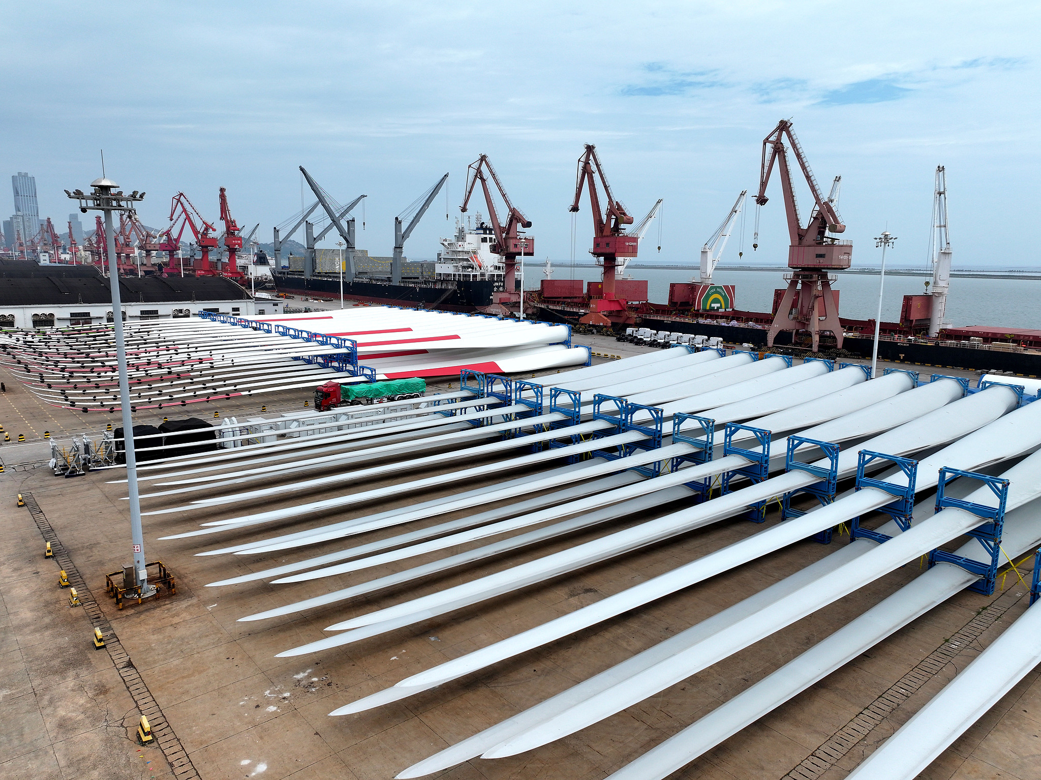 Chinese-made wind turbine units await loading for export at a port in Lianyungang, Jiangsu Province, China, July 22, 2026. /VCG