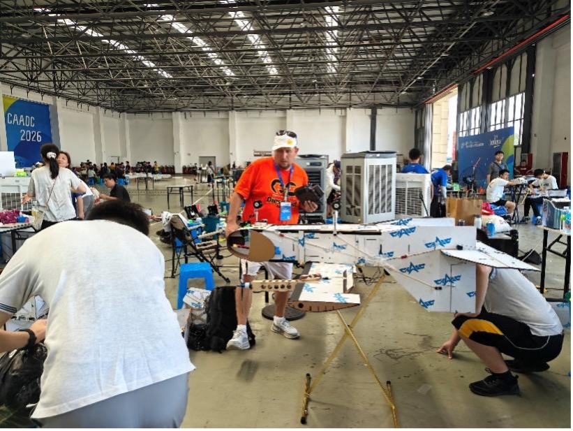 Igor, a Brazilian teacher at the Jiangning Campus of Nanjing Normal University Affiliated High School, instructs students at an aircraft design competition for young people in Deqing County, east China's Zhejiang Province, on July 27, 2026. /Photo provided by the organizing committee of the competition