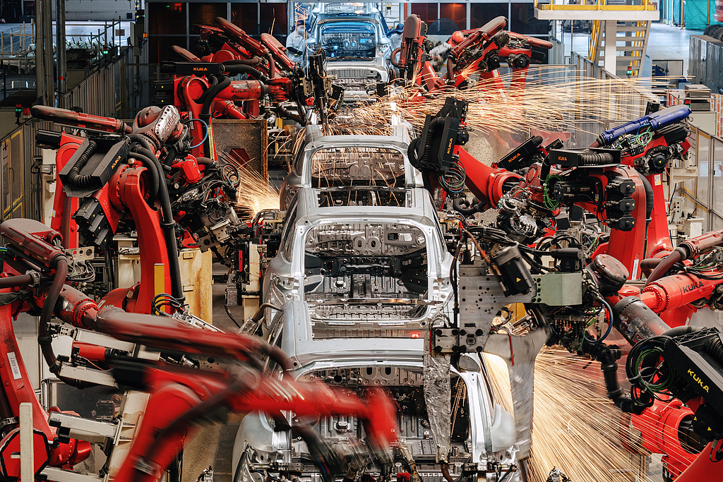 Production lines operate in an orderly manner at the welding workshop of an electric vehicle manufacturing base in Jinhua City, east China's Zhejiang Province, July 29, 2026. /CFP