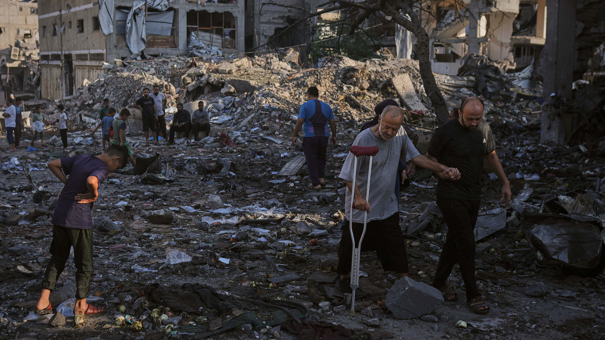 Palestinians inspect the rubble of a building and tents destroyed in an Israeli airstrike in Gaza City, July 30, 2026. /VCG