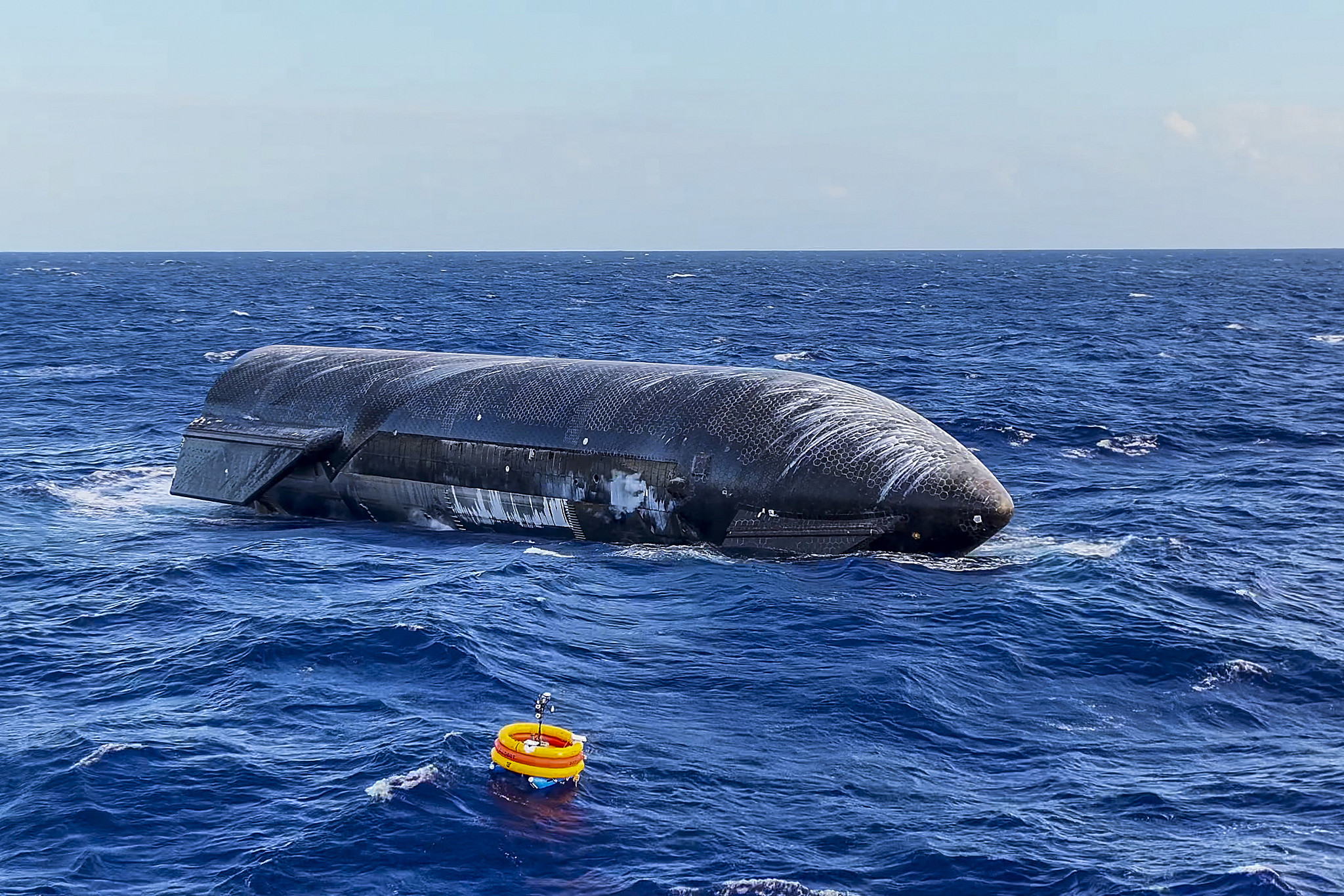 A side view of the Starship upper stage floating on the water after splashdown, Indian Ocean off Western Australia. /VCG