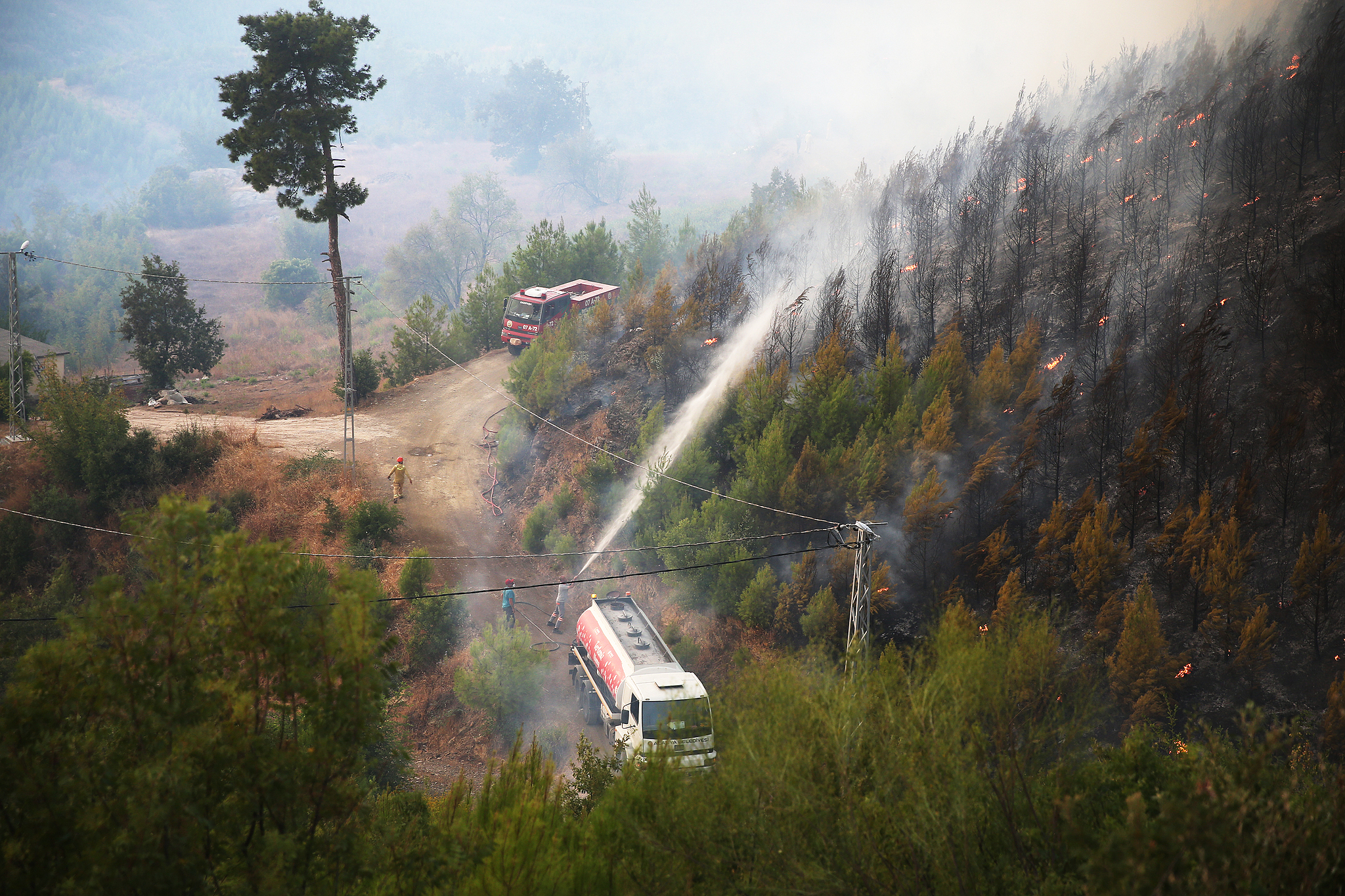 Aerial and ground crews battle a forest fire in the Alanya district of Antalya, Türkiye, July 29, 2026. /VCG