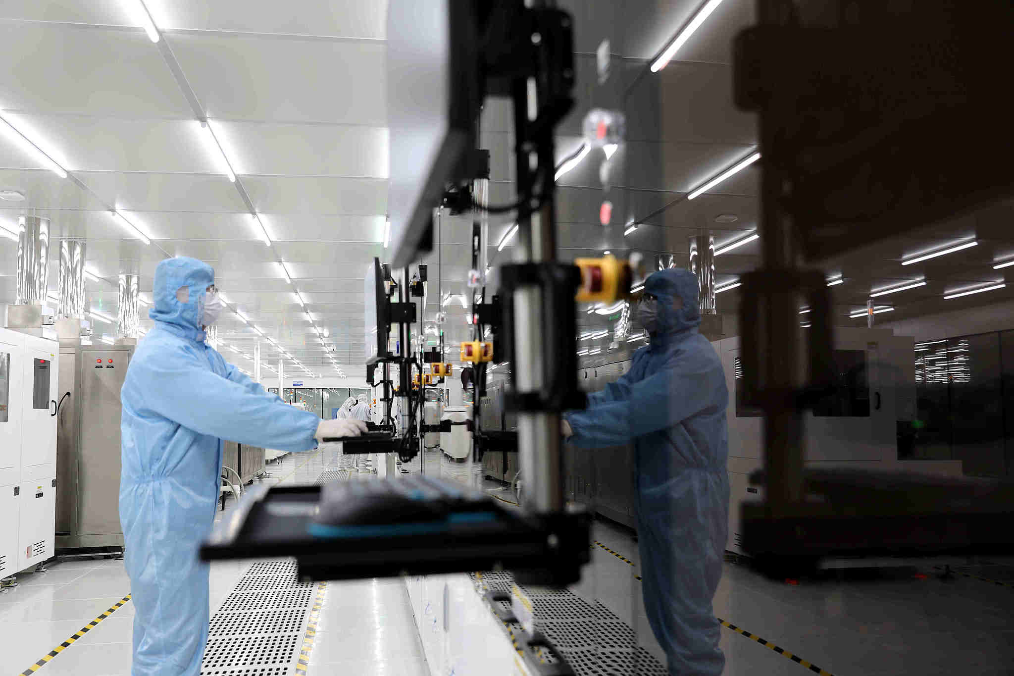 Workers test memory chips at a semiconductor packaging plant, Huzhou, Zhejiang Province, China, March 17, 2026. /VCG