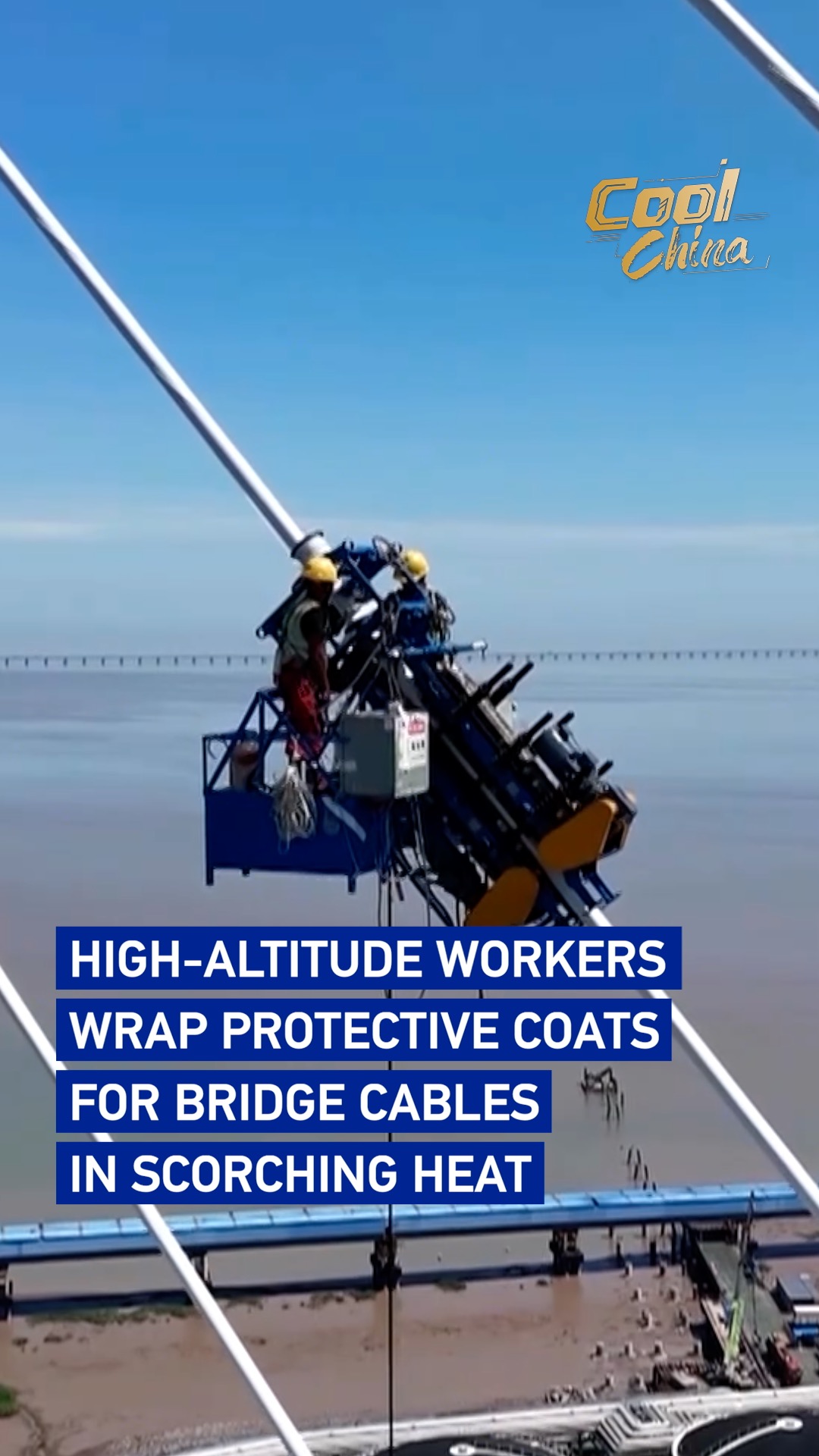 Workers wrap protective coats for bridge cables in scorching heat