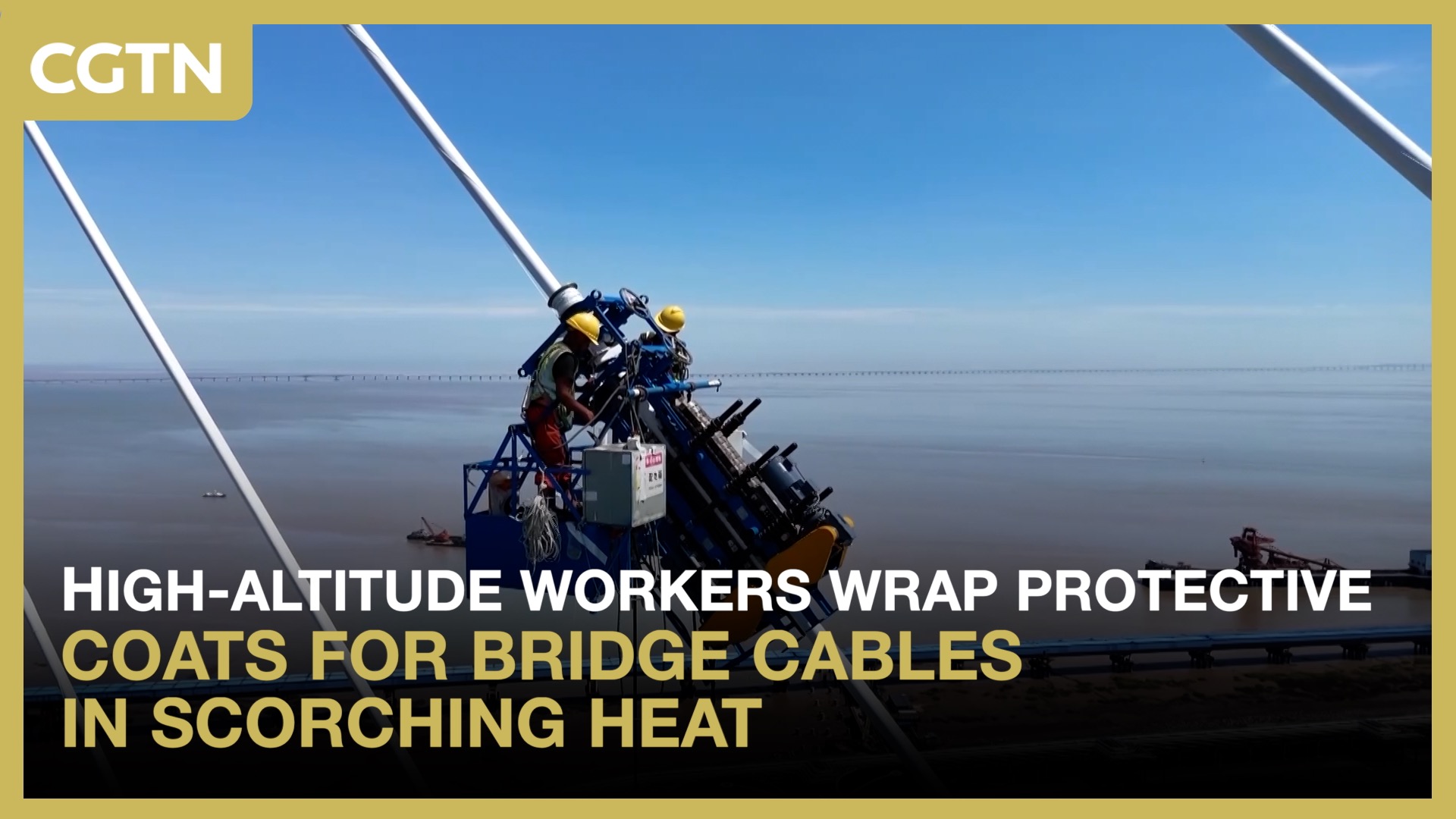 Workers wrap protective coats for bridge cables in scorching heat