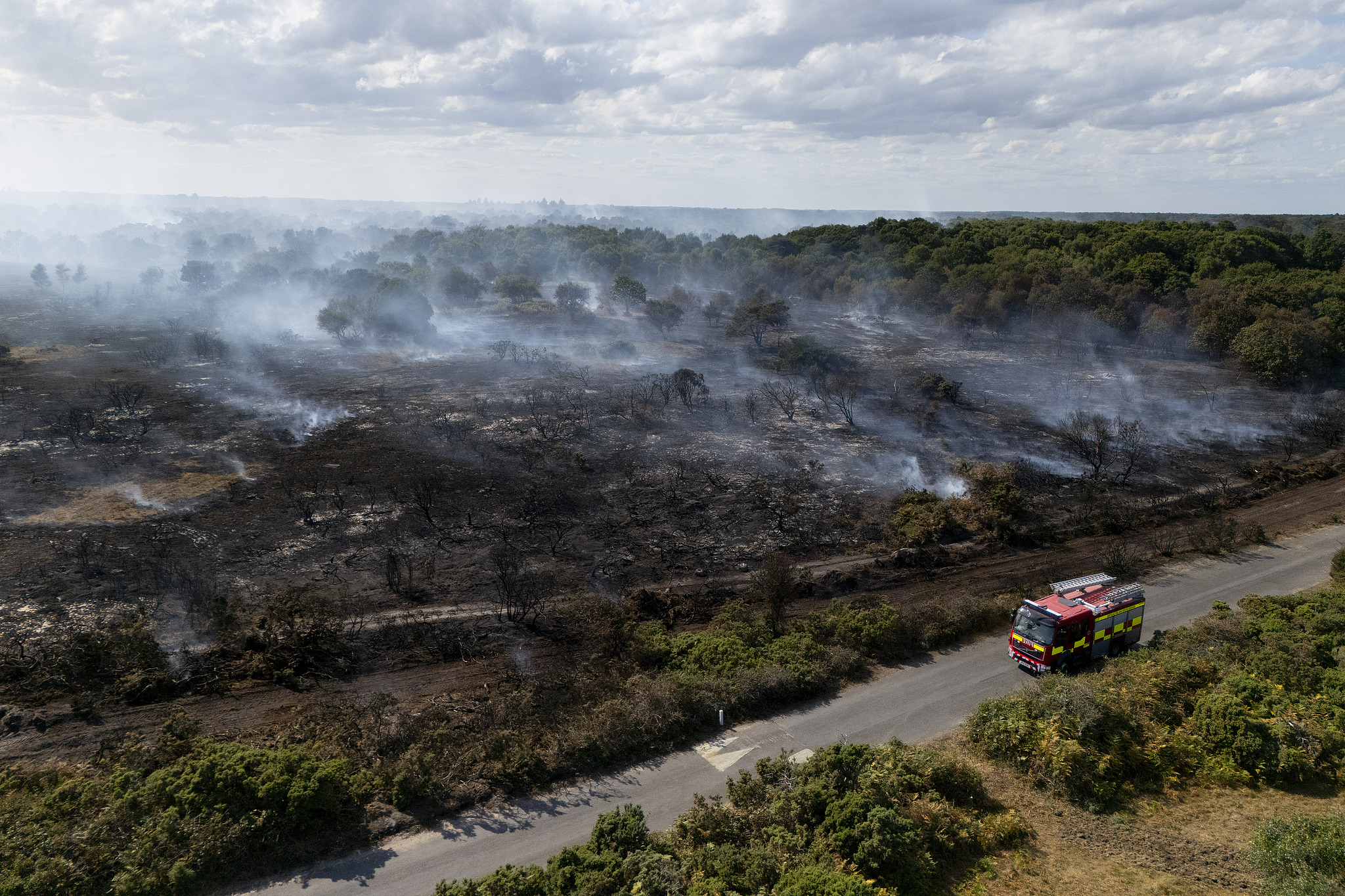An aerial view shows smoke rising from wildfires near Dunwich Heath in Suffolk, the UK, 31 July 2026. /VCG
