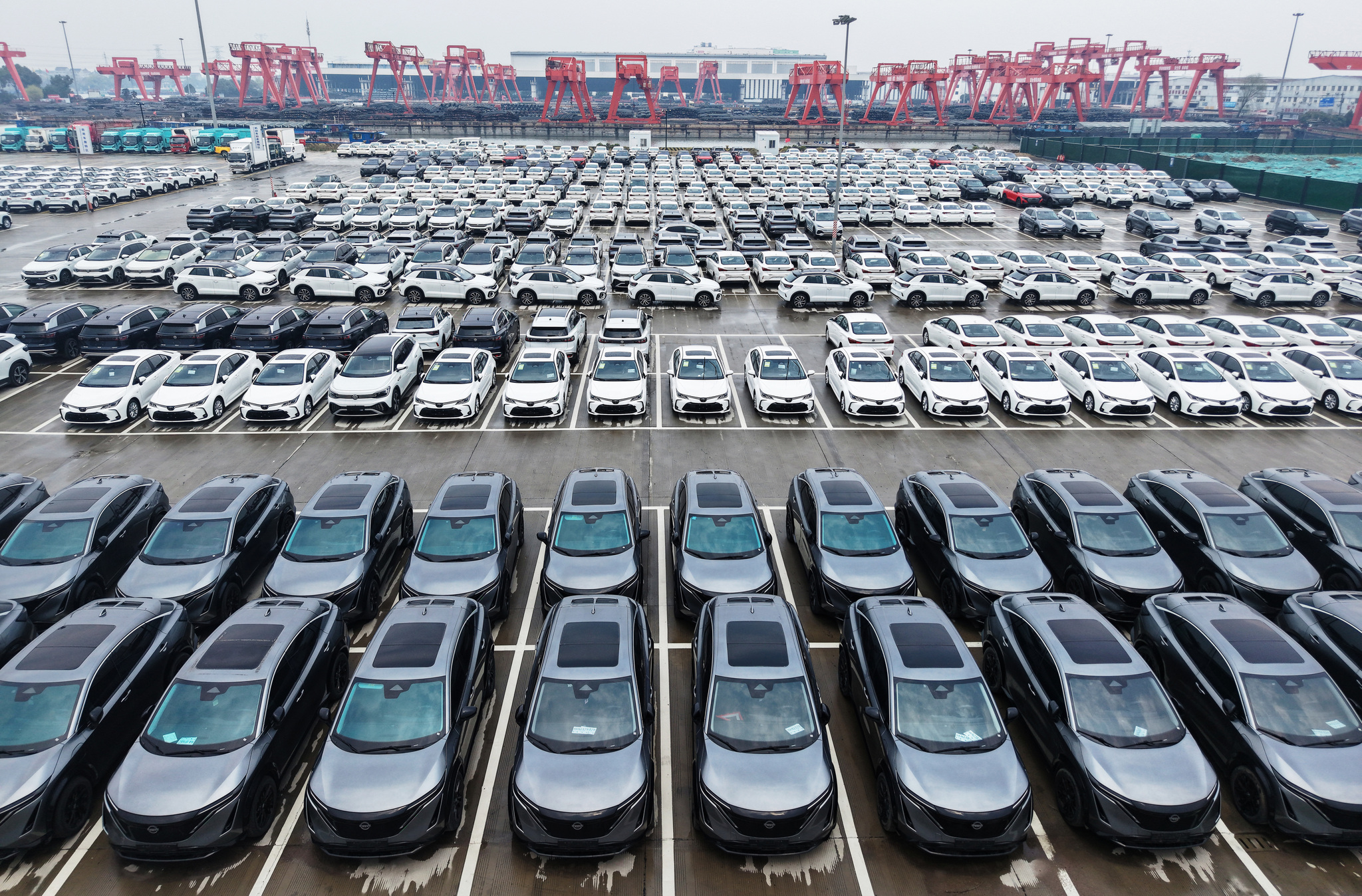 A fleet of electric vehicles awaits export at an international auto trade port along the Hangzhou section of the Grand Canal, Zhejiang Province, China, March 27, 2025. /VCG