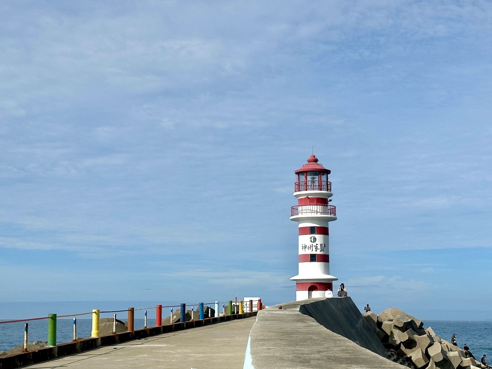A red-and-white striped lighthouse stands against the azure sea and sky on Shenzhou Peninsula in Wanning, Hainan Province on July 13, 2026. /CGTN