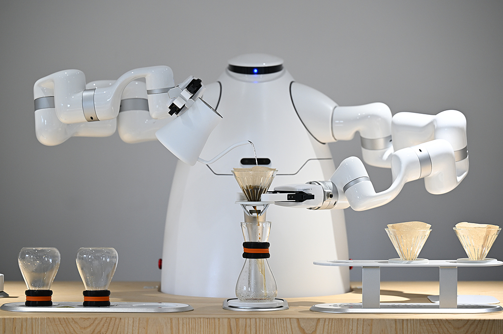 A robot undergoes hands-on training in household services at a robot training school in Hangzhou, Zhejiang Province in east China, July 7, 2026. /CFP