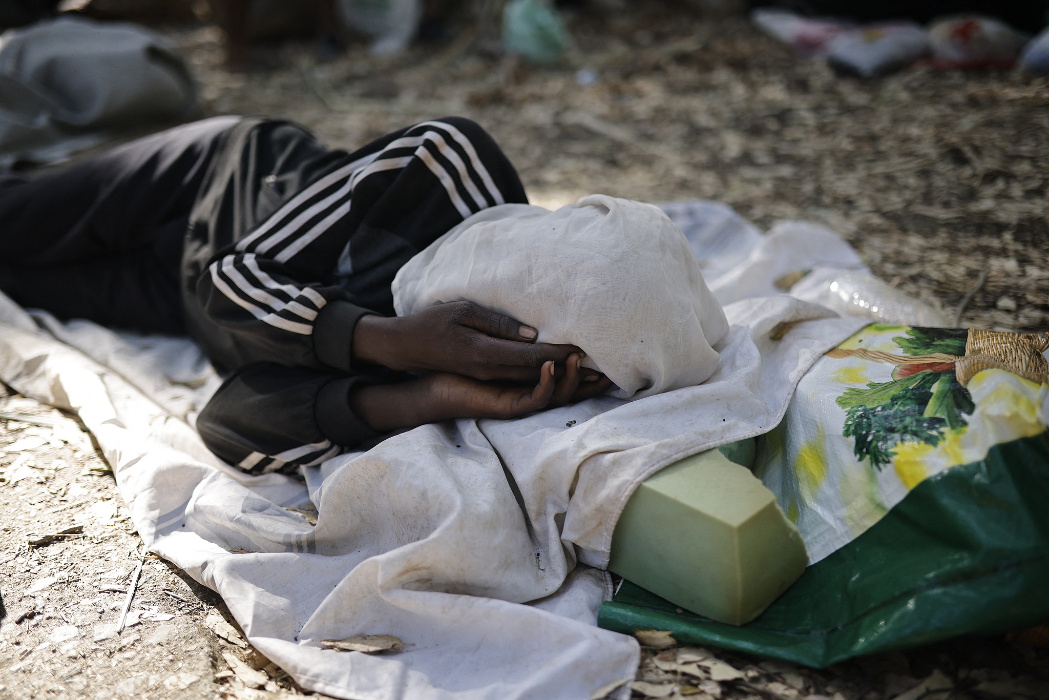 A person rests on the street in Ceuta, Spain, August 2, 2026. /CFP